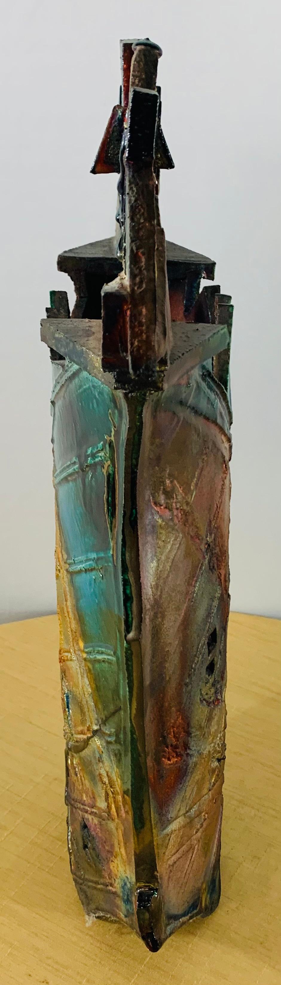 A unique and highly decorative glazed handmade Brutalist vase or sculpture. The multi-colorful vase/ sculpture features geometrical shapes and elaborated carving details. While painted in earthy tone colors. The art piece seems to be signed in the