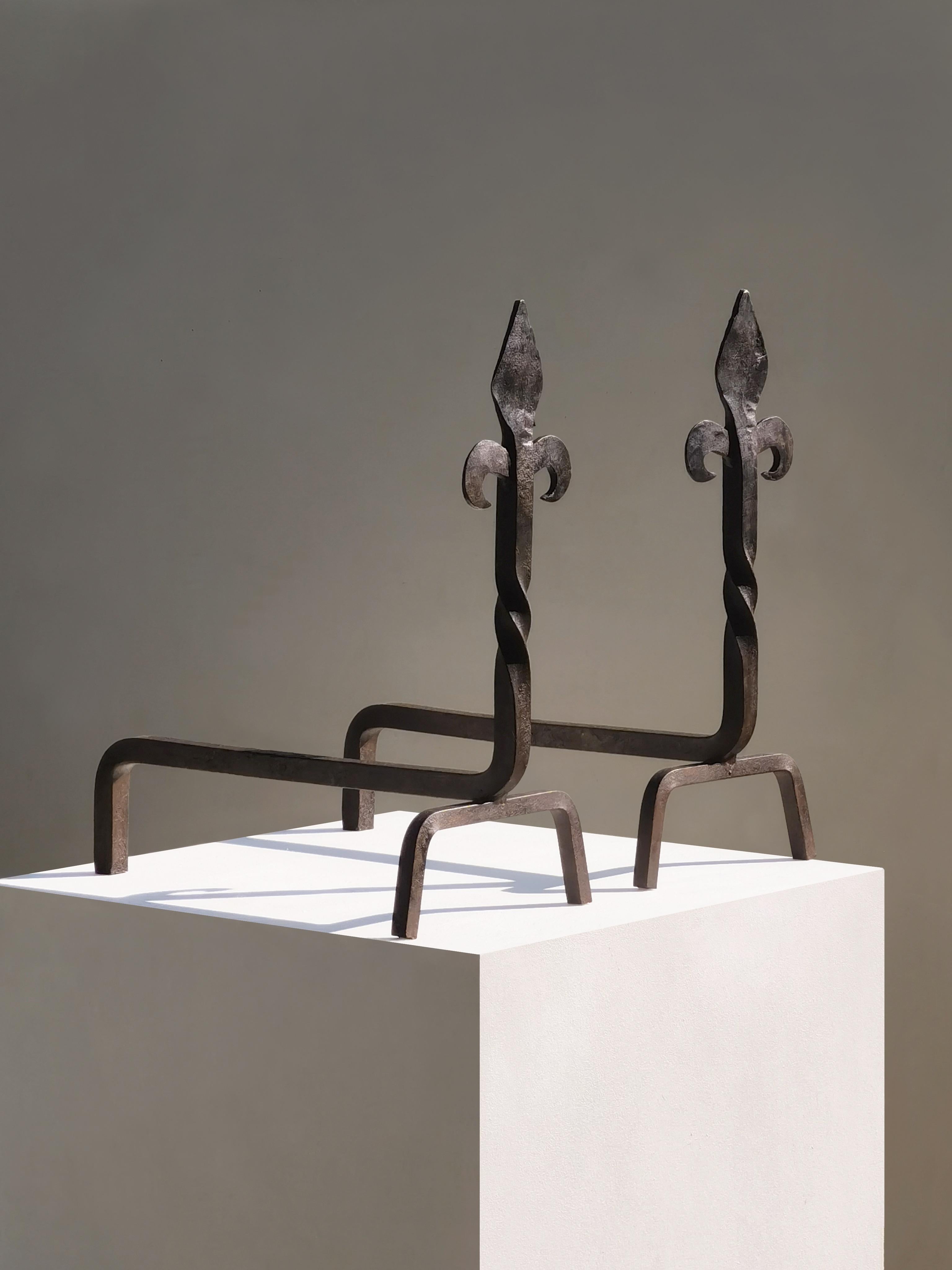 A simple and strong, pair of andirons, Neoclassical, Brutalist, to be attributed, massive wrought iron structures with interesting 