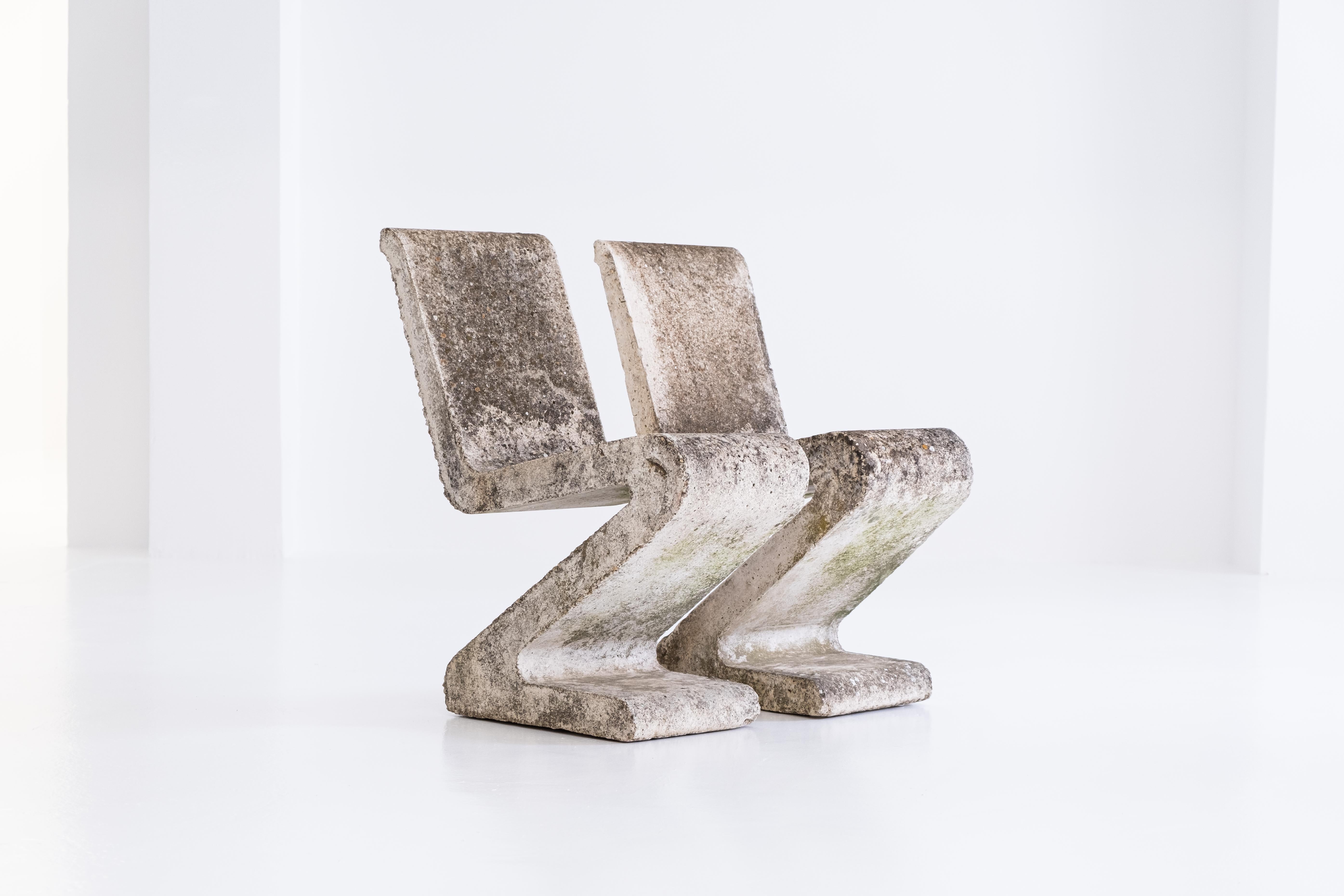 A very rare pair fo concrete garden chairs with beautiful patina. Reminding of the famous Rietveld ‚Zig Zag chair‘, the construction is completely industrial: steel-reinforced concrete. This internal steel skeleton gives the chair absolute stability