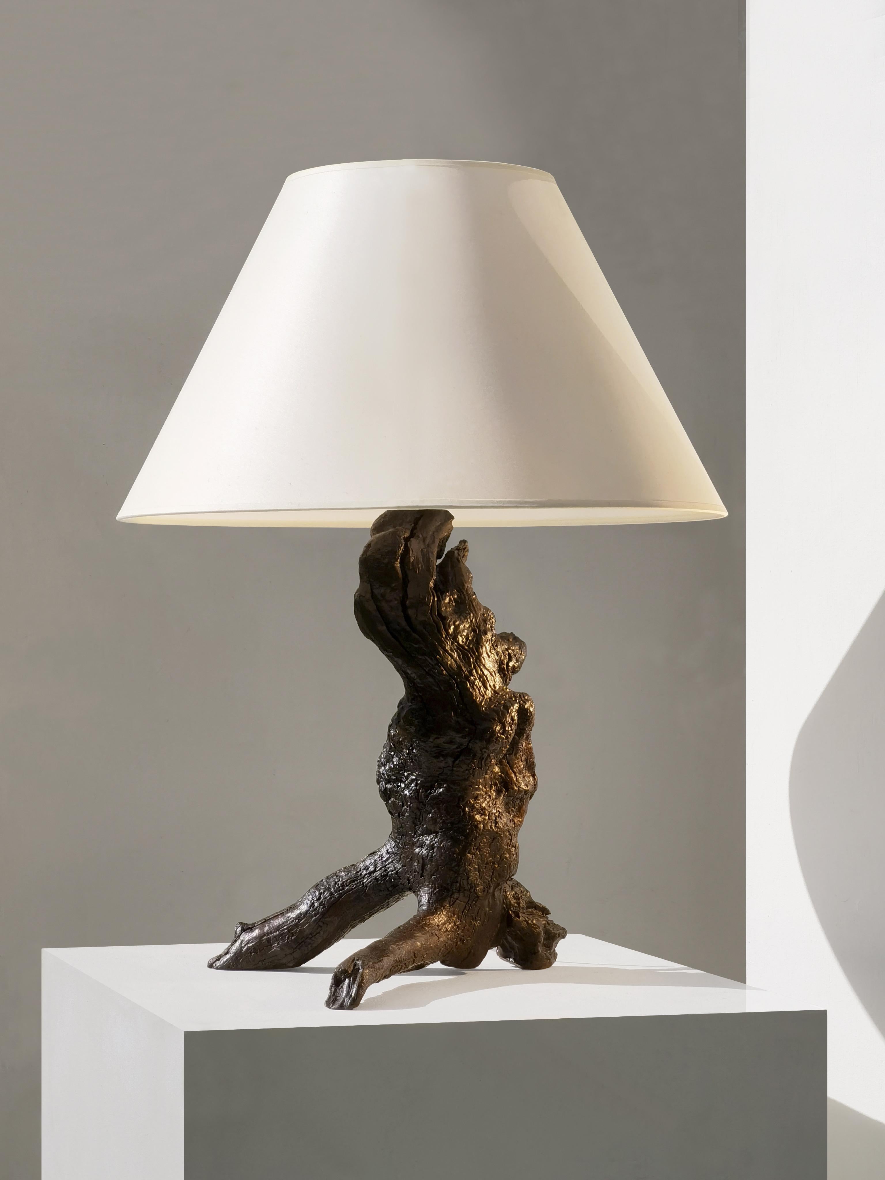 A strong and very dramatic, organic and almost zoomorphic, massive wood table lamp, made by an anonymous French artist from the 60s, using a natural piece of tree to form a tripod sculpture.

This is a great example of a Rustic Modern, Brutalist