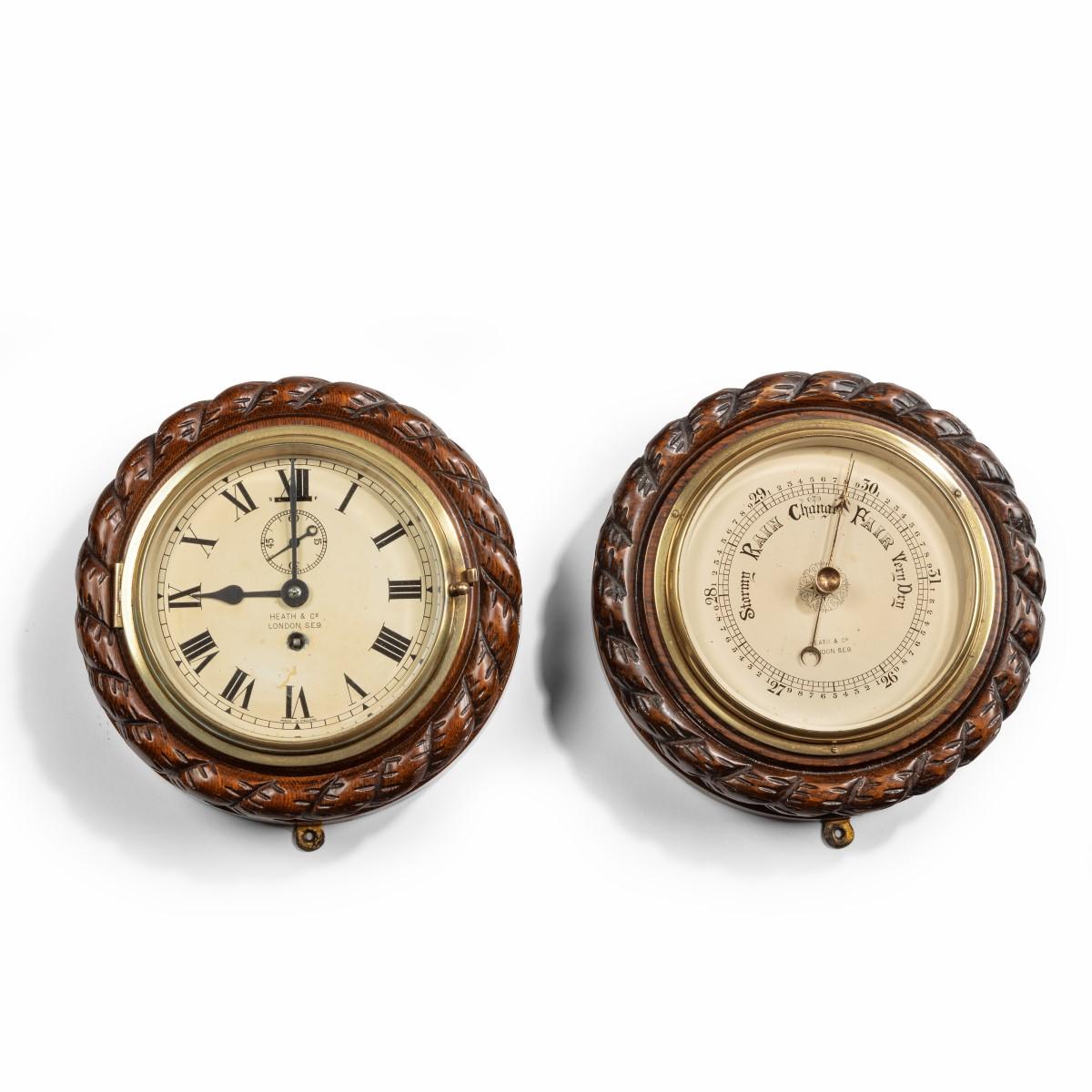 A bulkhead clock and barometer set by Heath & Co, each dial surrounded by a carved rope twist frame and inscribed ‘By Heath & Co London SE9’. English, circa 1900.

Footnote: Heath & Co (also known as Hezzanith) was founded 1845 and specialised in