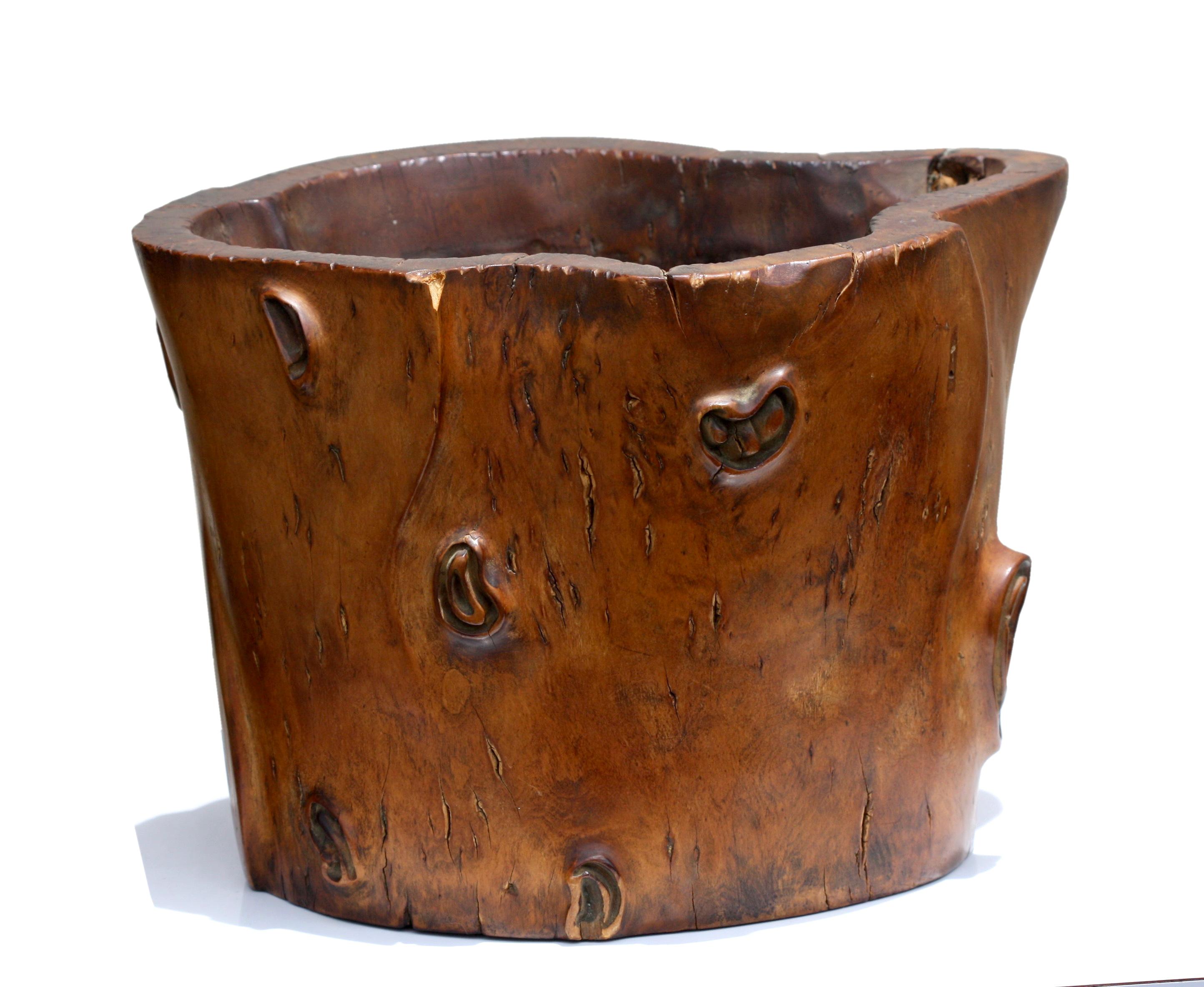 A burl wood brush pot, Qing Dynasty
Chinese, late 19th century, of cylindrical form with a flared lip, the well patinated surface of a warm caramel-brown color,
Measures: 9.50 inches wide, 7 inches high.