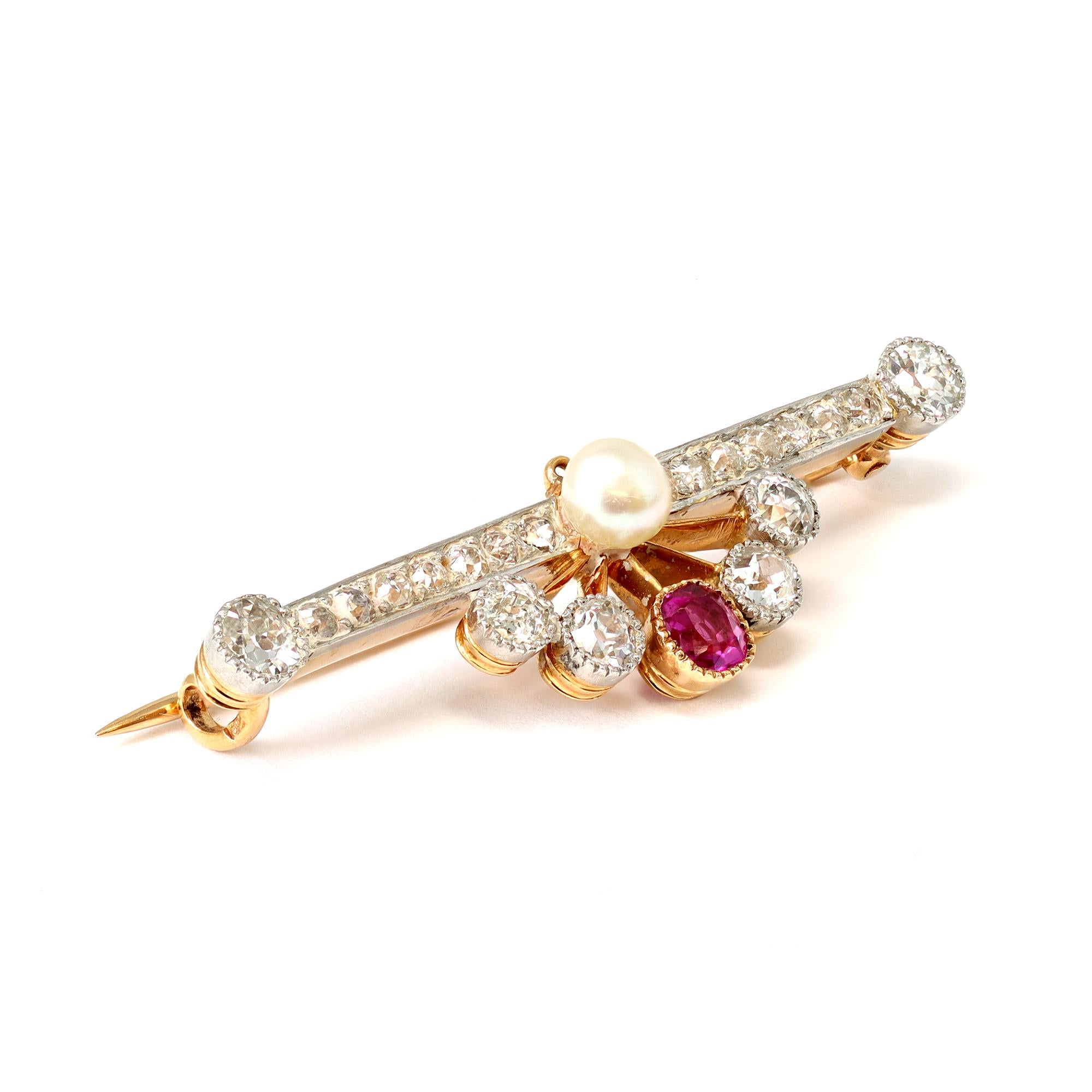 A late Victorian brooch circa 1900, featuring a cushion cut shape Burmese ruby with a strong pinkish red hue adorned with old mine cut diamonds. The ruby has an estimated weight of 0.40 carats, the diamonds weigh approximately 1.40 carats GH color