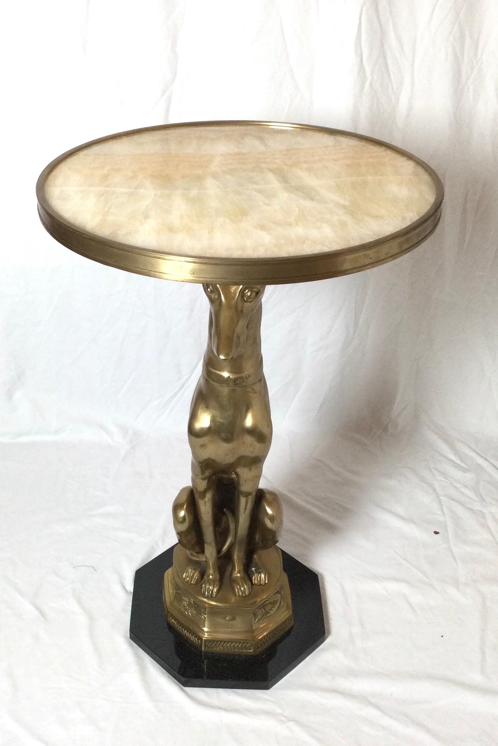 A cast brass whippet dog table with round onyx top and heagnal black base. The burnished surface with the sone top and base more polished. Measures: 30 inches tall, 17 inches Diameter.