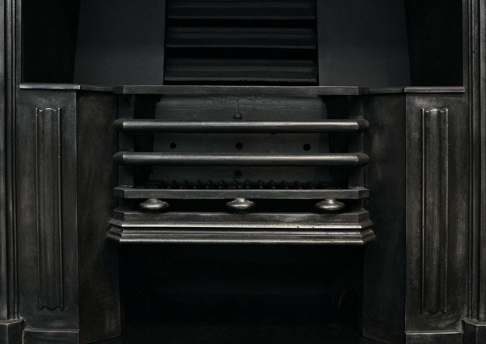 A burnished cast iron register grate. The outer frame with heavy moulding, the burning area with shaped front bars, flanked by moulded hobs. English, mid 19th century.  

Width At Front:	915 mm      	36