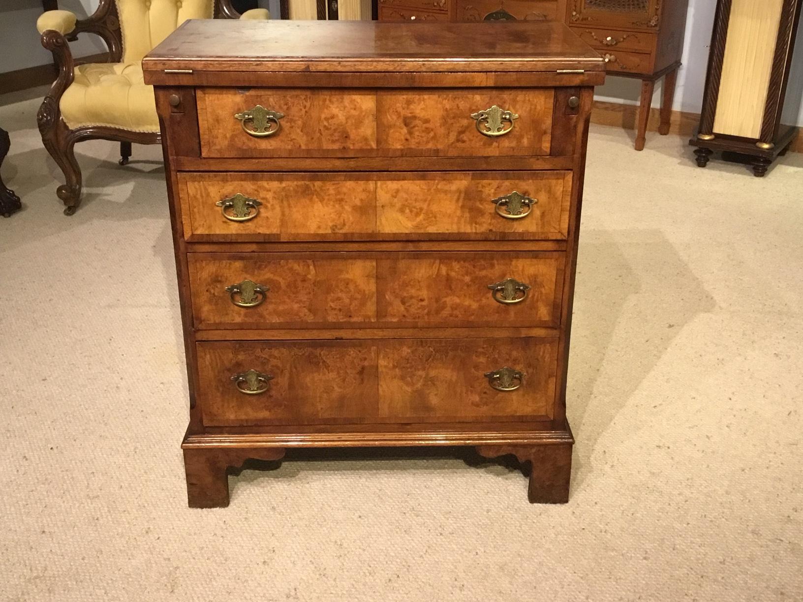 A burr walnut George I Style bachelors chest. The rectangular hinged top veneered in beautifully figured burr walnut and banded in walnut, opening to reveal a burr walnut surface which is supported on two lopers. Having an arrangement of four