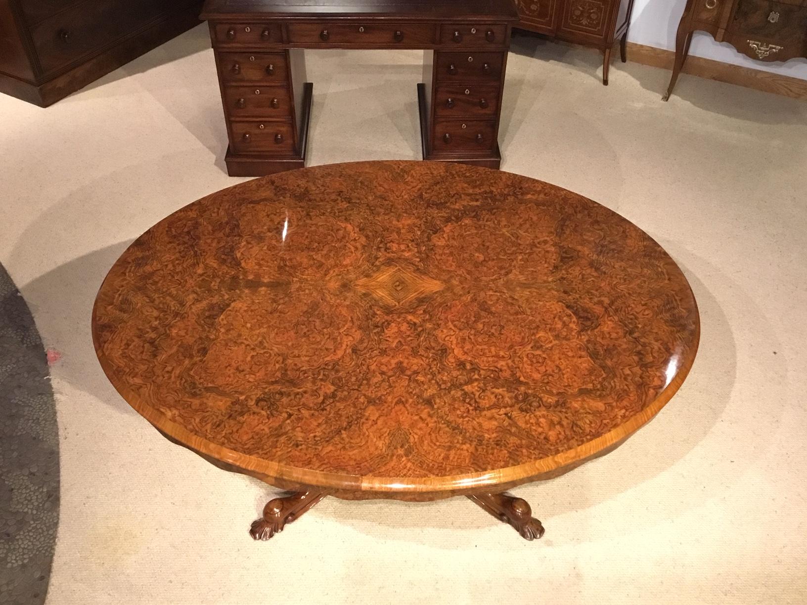 A burr walnut Victorian period breakfast/loo table. Having an oval tilting top veneered in beautifully figured burr walnut with a shaped burr walnut veneered frieze. Supported on a turned bulbous walnut column with four carved cabriole supports with