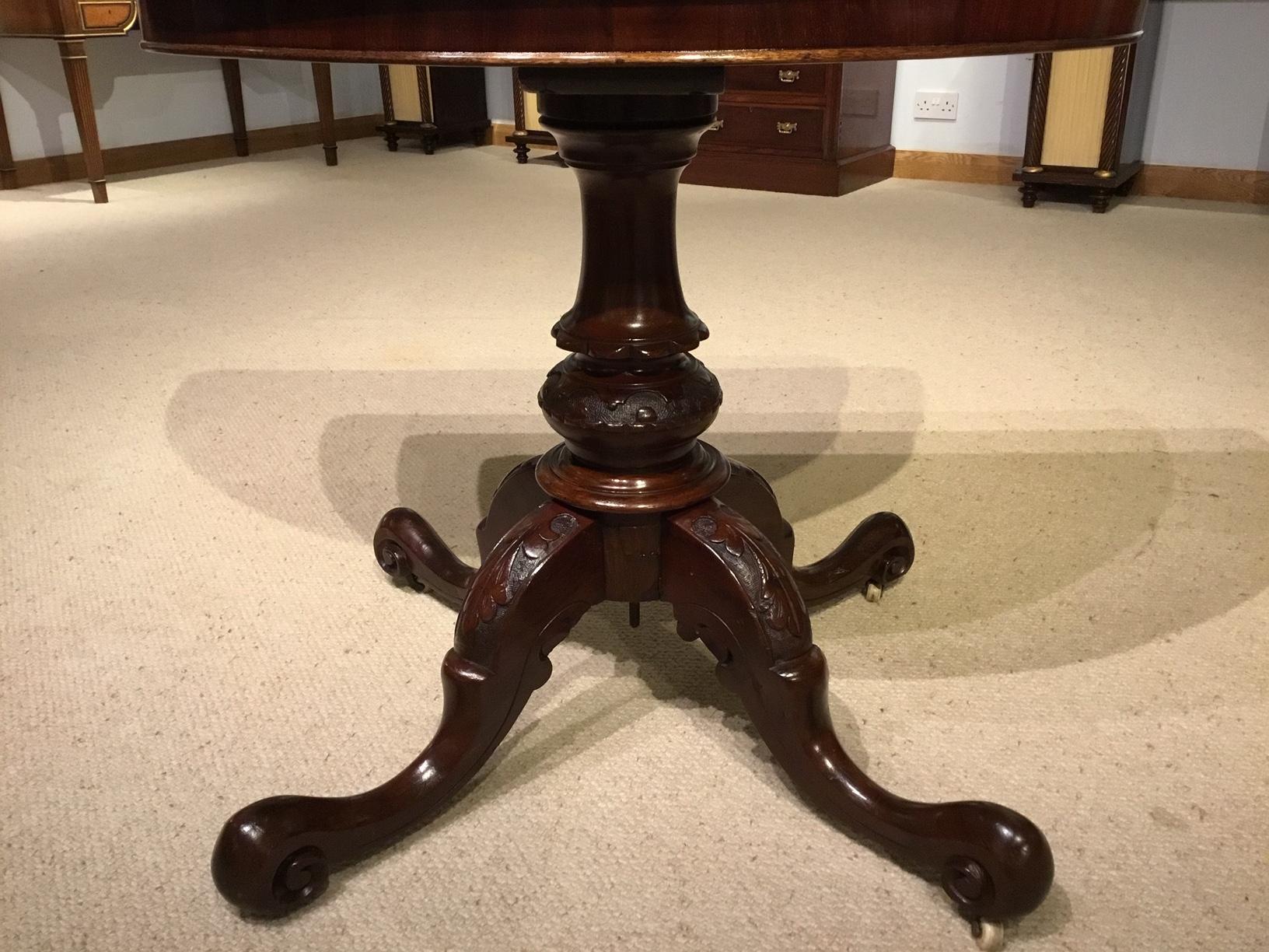 A burr walnut Victorian Period fold over card table. The demilune top is veneered in beautifully figured burr walnut and opens to reveal a baize playing surface with a walnut border. Supported on a turned and carved column with four acanthus carved