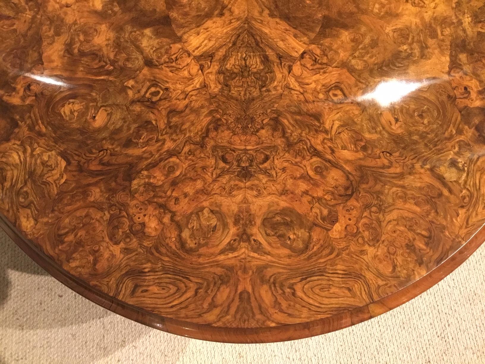A burr walnut Victorian Period oval antique coffee table. The oval top veneered in tightly figured burr walnut with a burr walnut frieze and raised on turned and carved column supports with swept feet. English circa 1870

Dimensions: 47