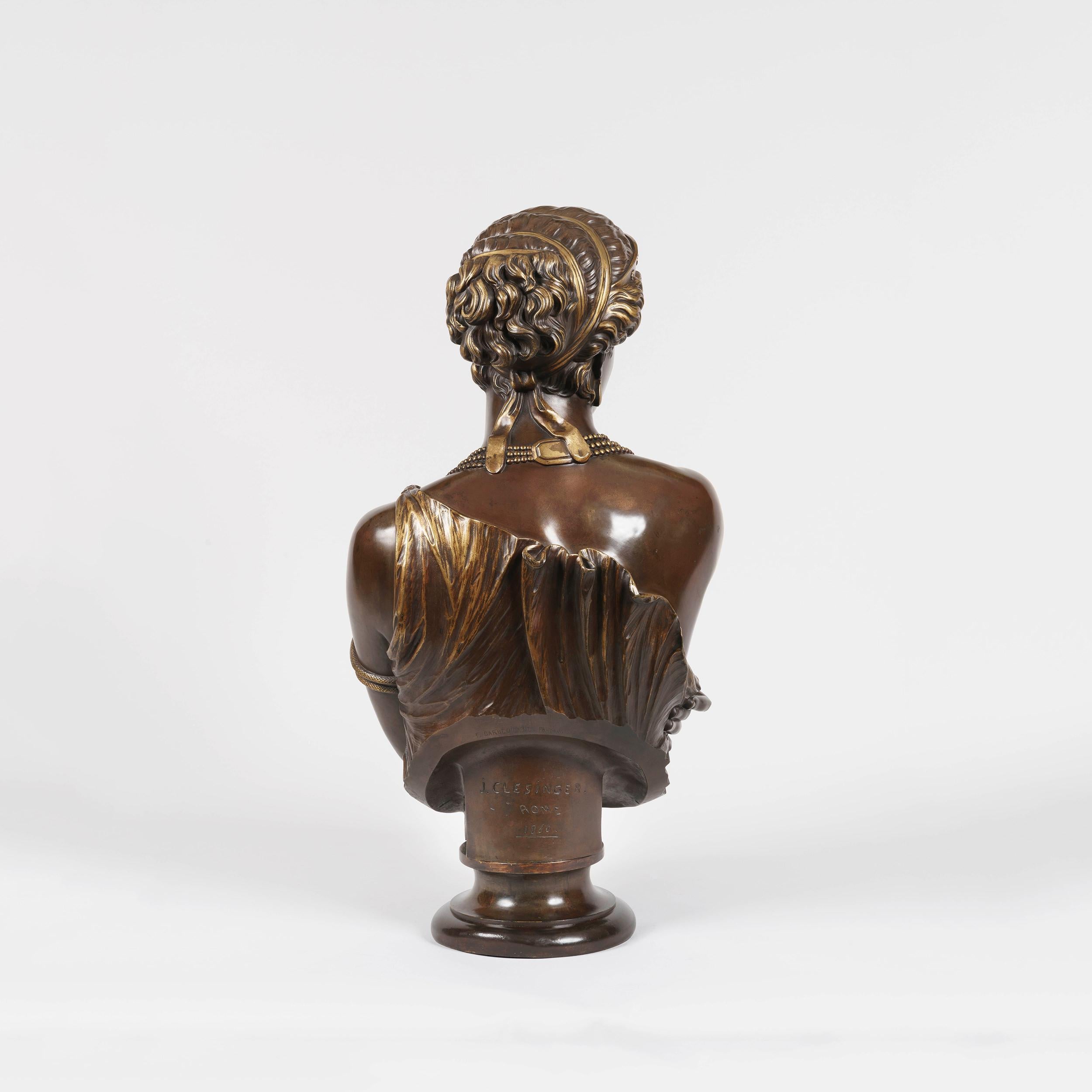 A Bust of 'Helen of Troy'
Sculpted by J-B Clesinger, and cast by the Barbedienne Foundry

Cast in bronze, and having three distinct patinations of natural bronze, brown and gilt. Marked to the base of the bust 'J. Clesinger Rome 1860' and the