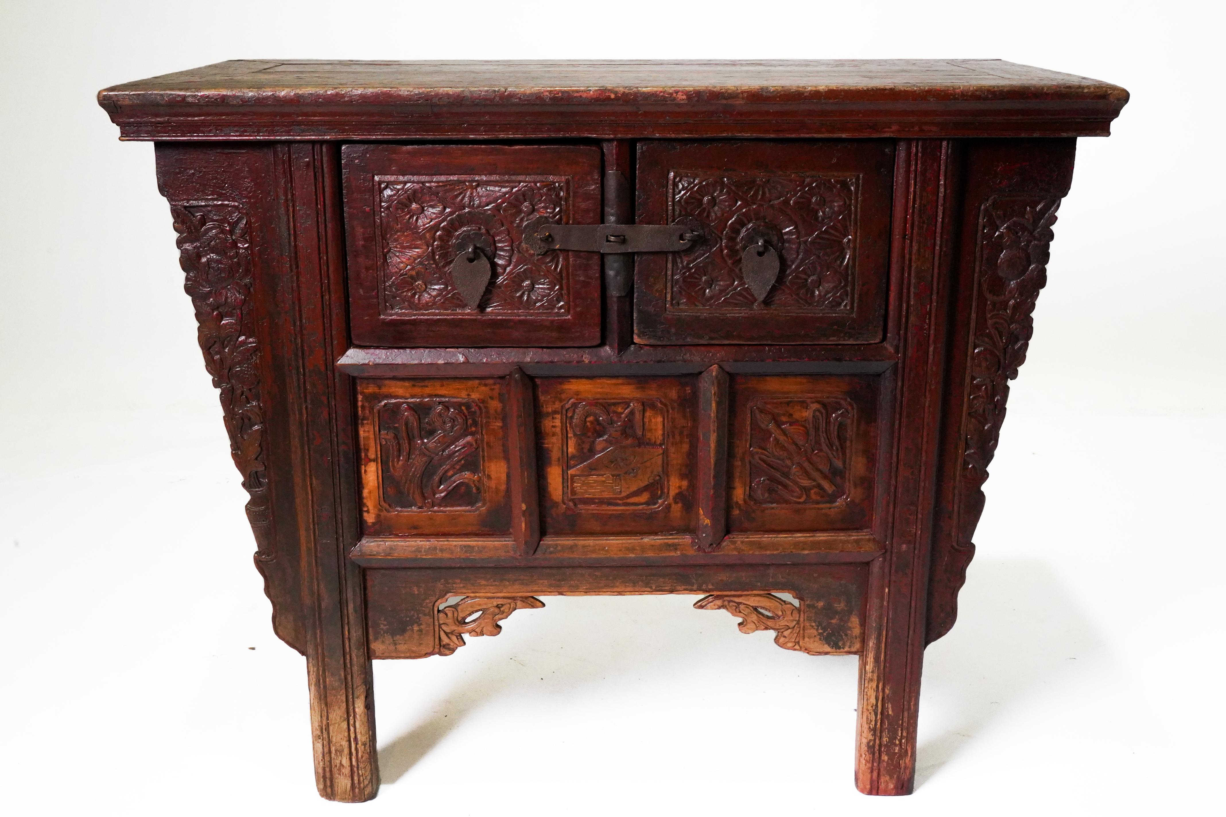 This elegant small coffer features a floating panel top and two drawers sitting above storage area with three carved panels. The front of the drawers and the lower panels are carved with floral rosettes and other auspicious symbols. Carved floral