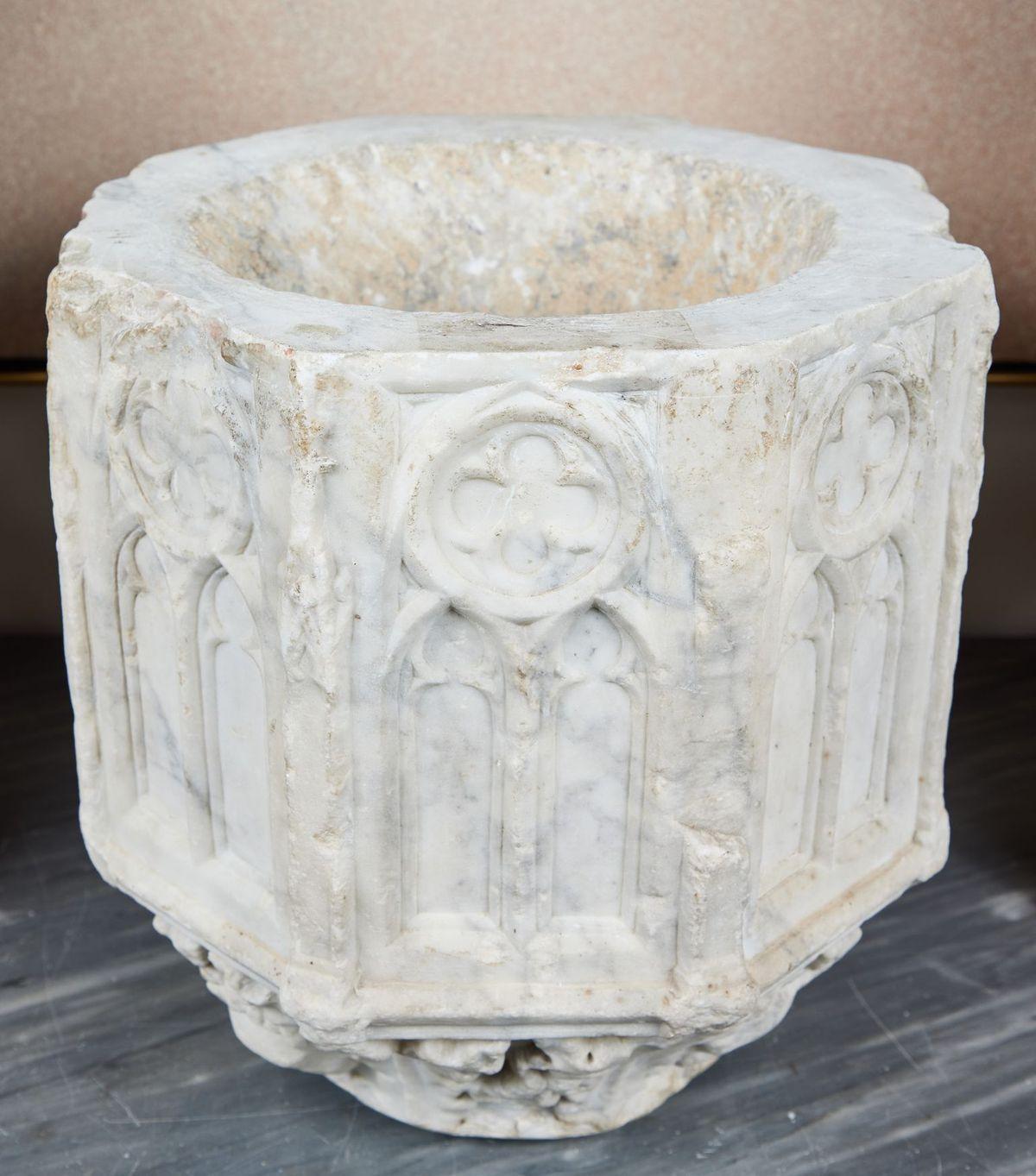 Absolutely stunning, period, hand-carved solid marble downspout featuring a 360 degree series of reliefs depicting iconic, arched Gothic windows surmounted by quatrefoil medallions. The whole on a tapered base of foliate relief carvings.