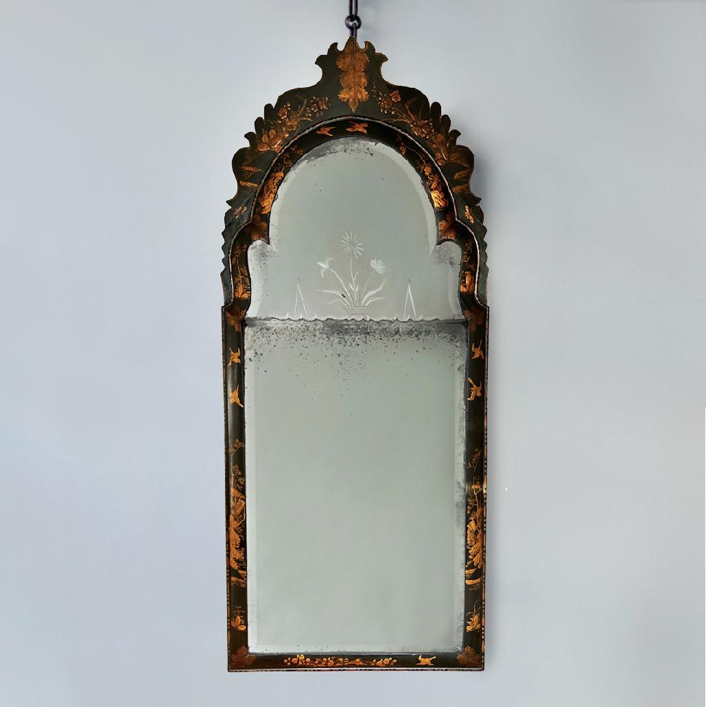 A fabulous English C19th Queen Anne style black and gilt chinoiserie decorated pier mirror.

The black lacquered cushion frame with gilt heightened pavilions, birds and butterflies in a wooded landscape.

The sparkly softly bevelled mercury plates