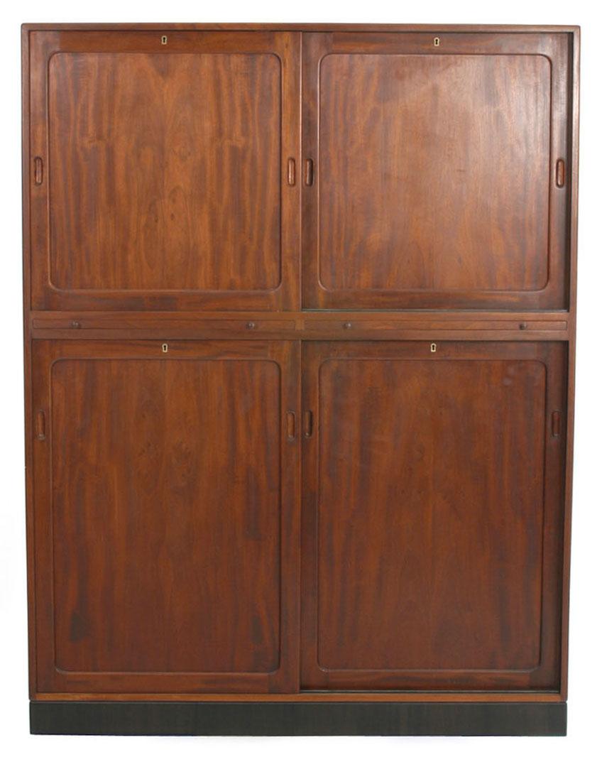 A large cabinet with sliding doors in solid Cuban mahogany. Interior with numerous pull-out trays.
Designed by Kaare Klint in 1933 and expertly crafted by master cabinetmakers' Rud. Rasmussen, Denmark