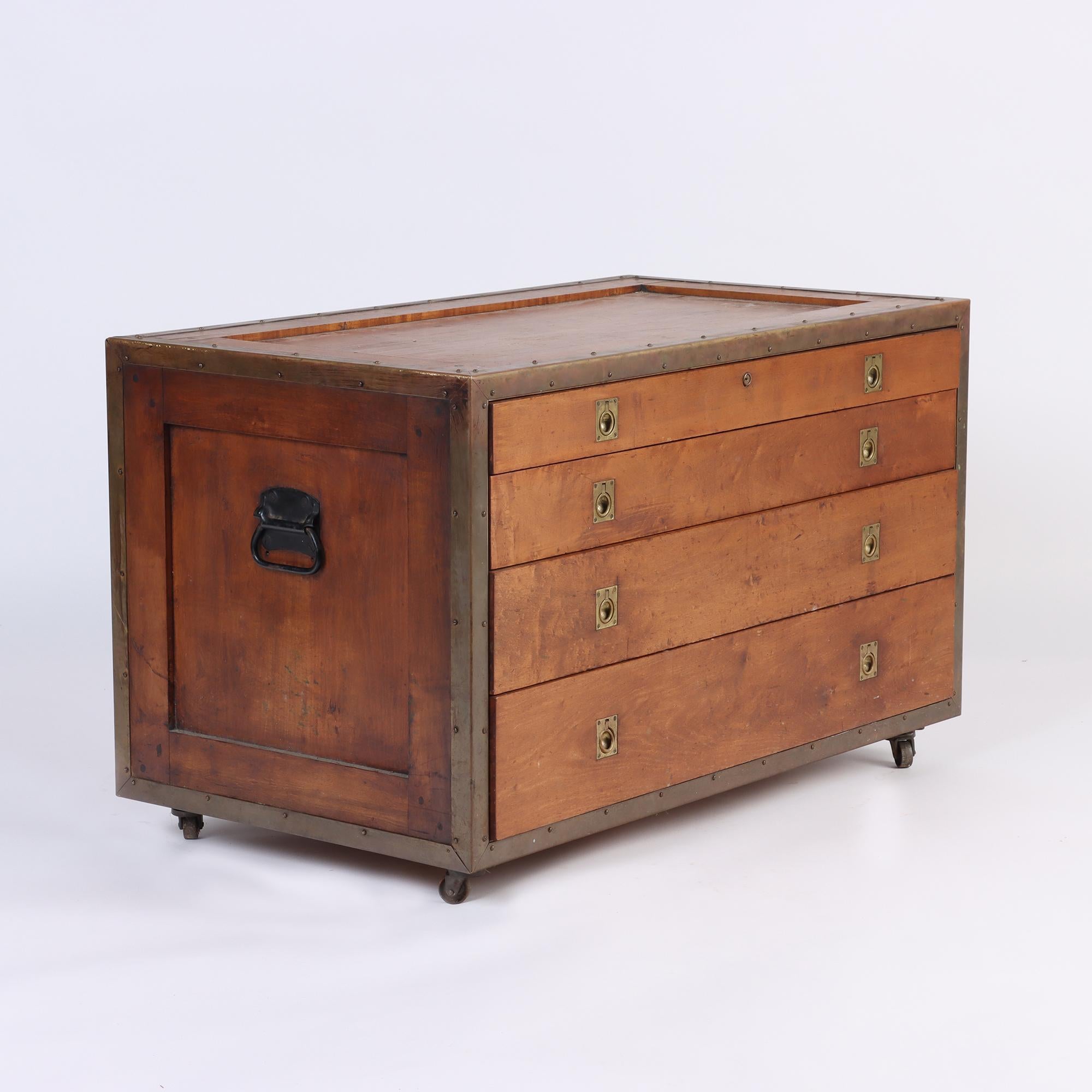 Campaign chest of drawers in beautiful condition, 1940's. Four drawers on top of one another gradually getting large in size. Chest is on Wheels.
 Wrapped on all edges with brass and original brass fittings throughout.
 American.
