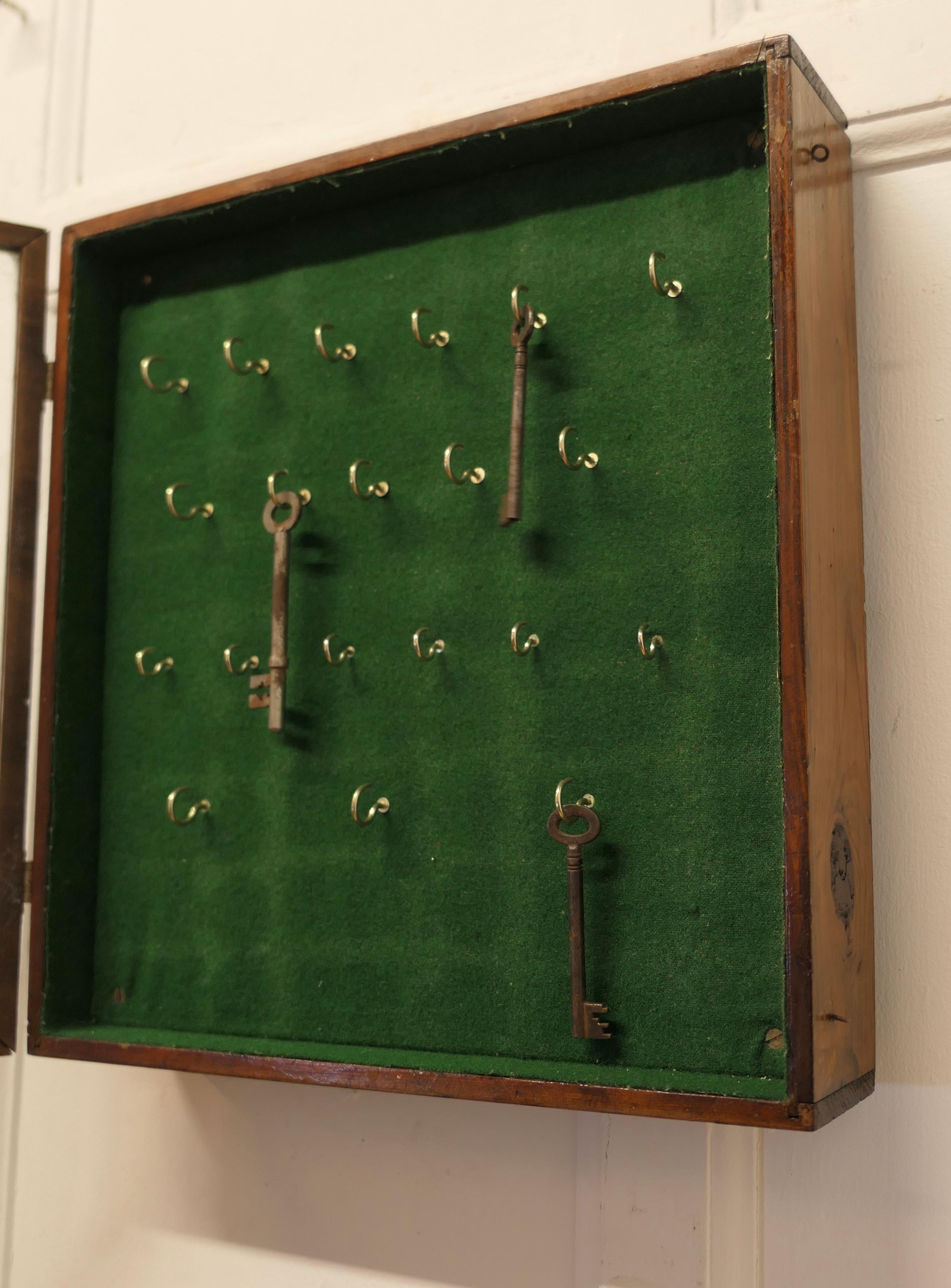 Walnut A Campaign Style 20 Hook Wall Hanging Key Cupboard   A glass fronted key cupboar