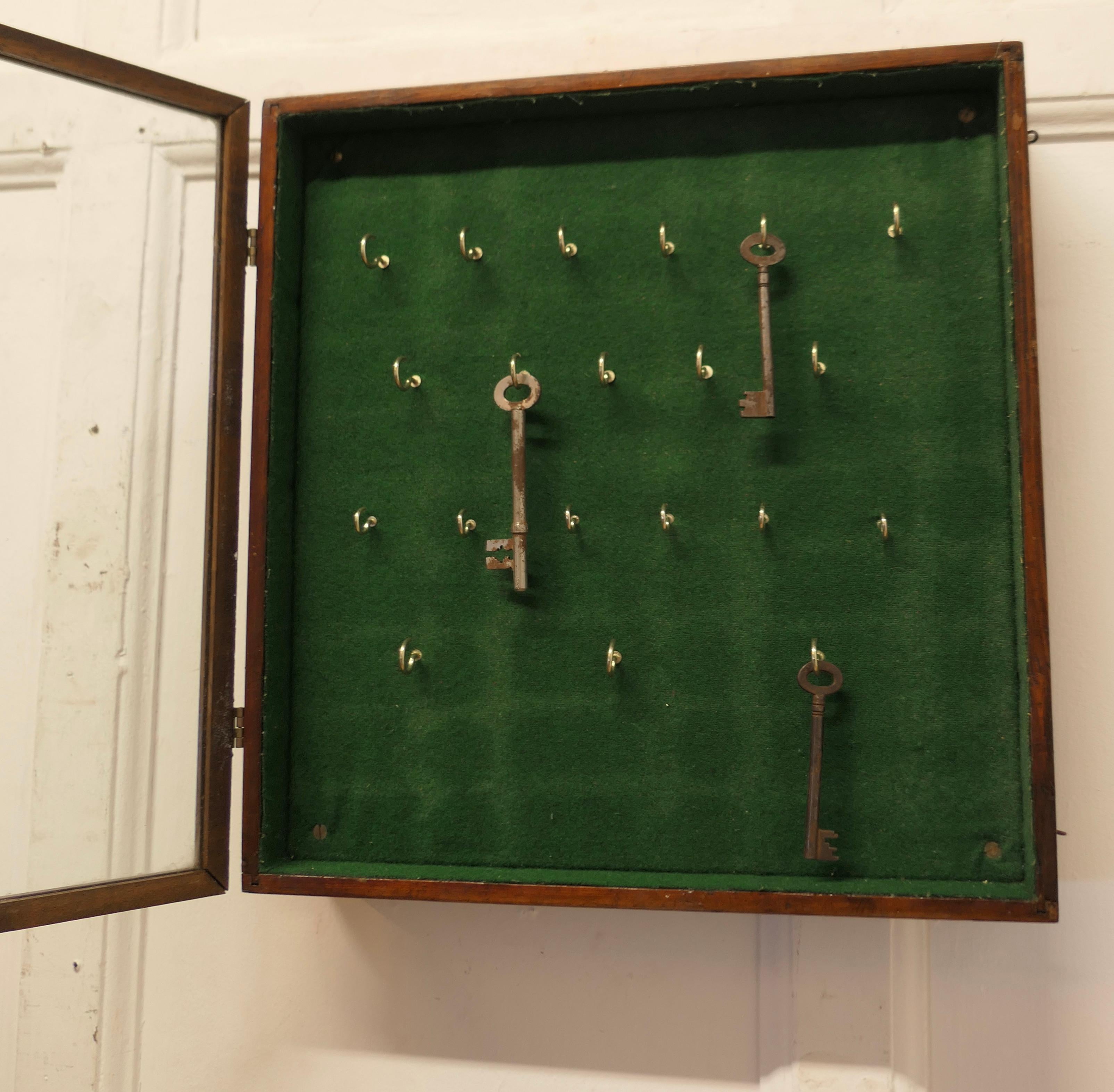 A Campaign Style 20 Hook Wall Hanging Key Cupboard   A glass fronted key cupboar 1