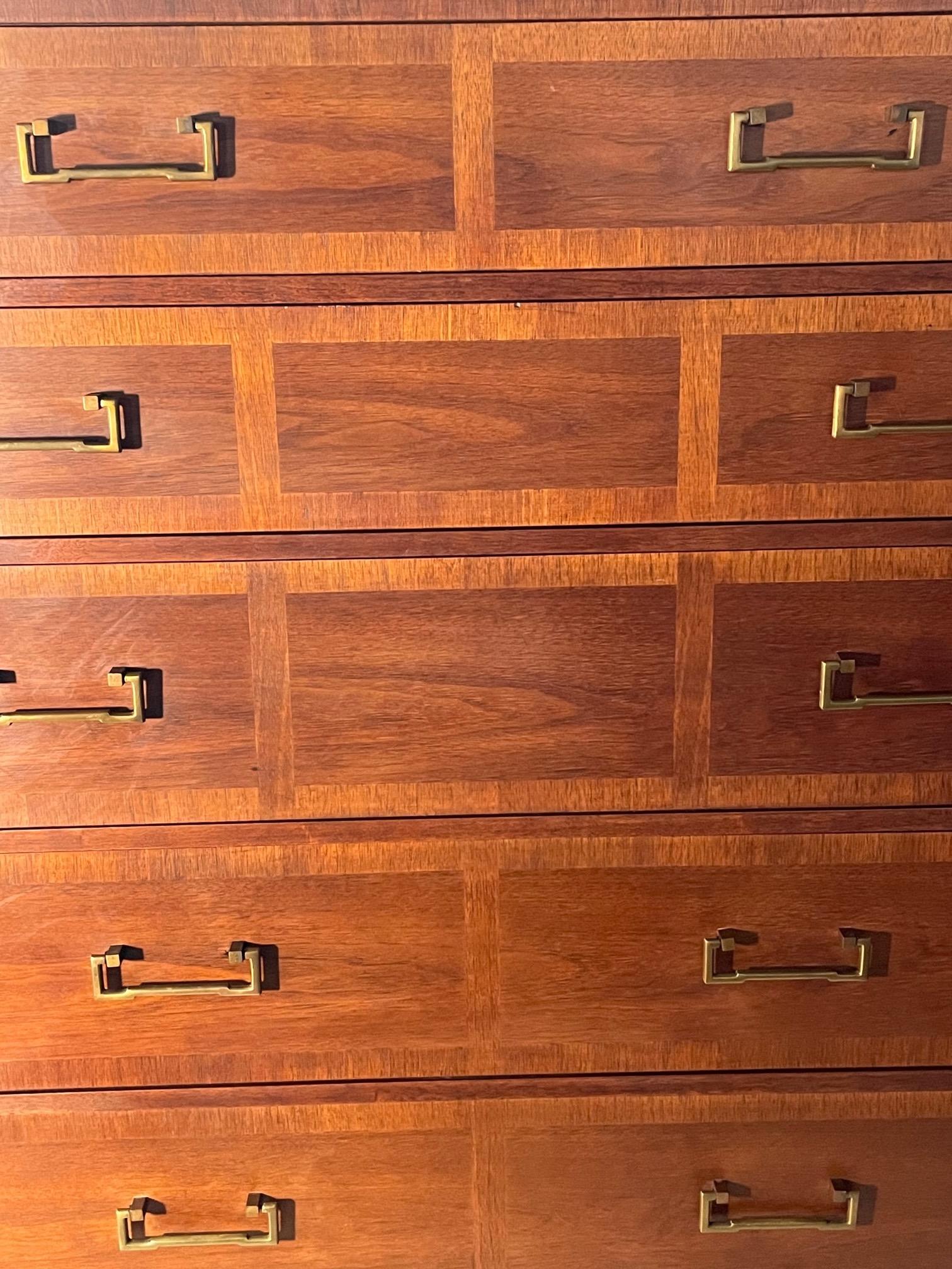 An unusual Campaign style, high chest by Sligh Furniture of Grand Rapids, circa 1950s. Walnut with beautiful graining and solid brass hardware.