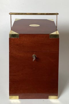 A Campaign Style Mahogany Tantalus With Crystal Decanters and Glasses.