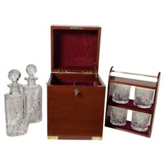 A Campaign Style Mahogany Tantalus With Crystal Decanters and Glasses.