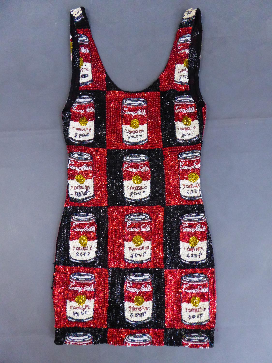 Circa 1990
England

A cocktail lycra mini dress fully embroidered with red and black checkered sequins representing one of the most famous work of Andy Warhol, Campbell’s soup cans, created in 1962. Sleeveless low-cut neckline and backless, this