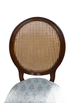 A caned back Louis XVI style oval back dining chair for custom finish.