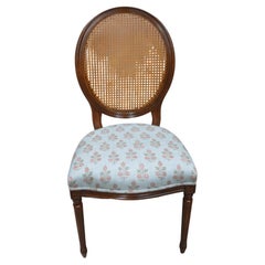 A caned back Louis XVI style oval back dining chair for custom finish.