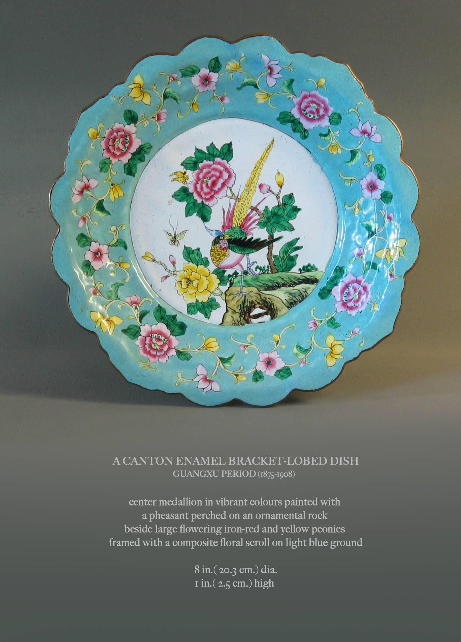 A canton enamel bracket-lobed dish, Guangxu period (1875-1908), with a centre medallion in vibrant colors painted with a pheasant perched on an ornamental rock beside large flowering iron-red and yellow peonies framed with a composite floral scroll