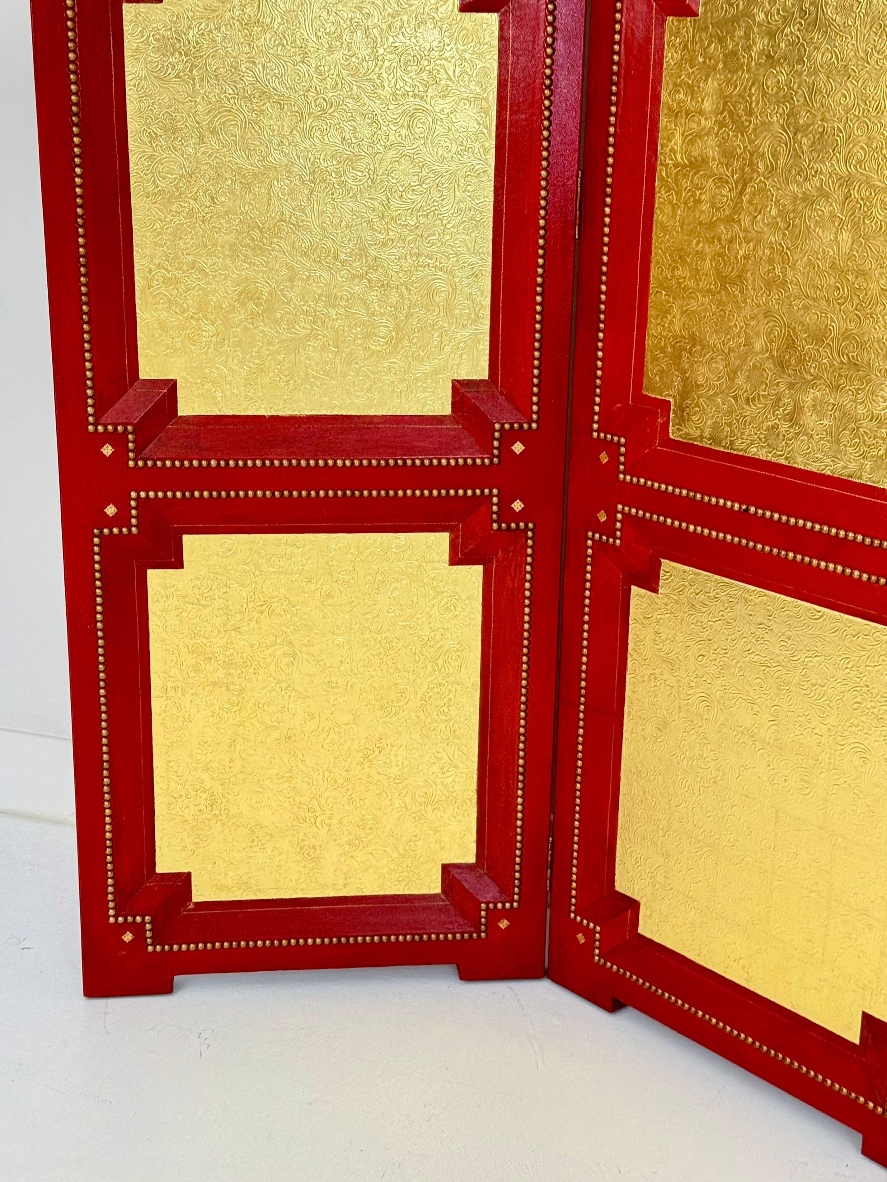 A dramatic three-panel folding screen designed in 1994 by Peter Schifando for Mrs. Freeman Gosden, created specifically for her Beverly Hills residence decorated by the legendary William Haines. The screen is wrapped in vibrant red leather and inset