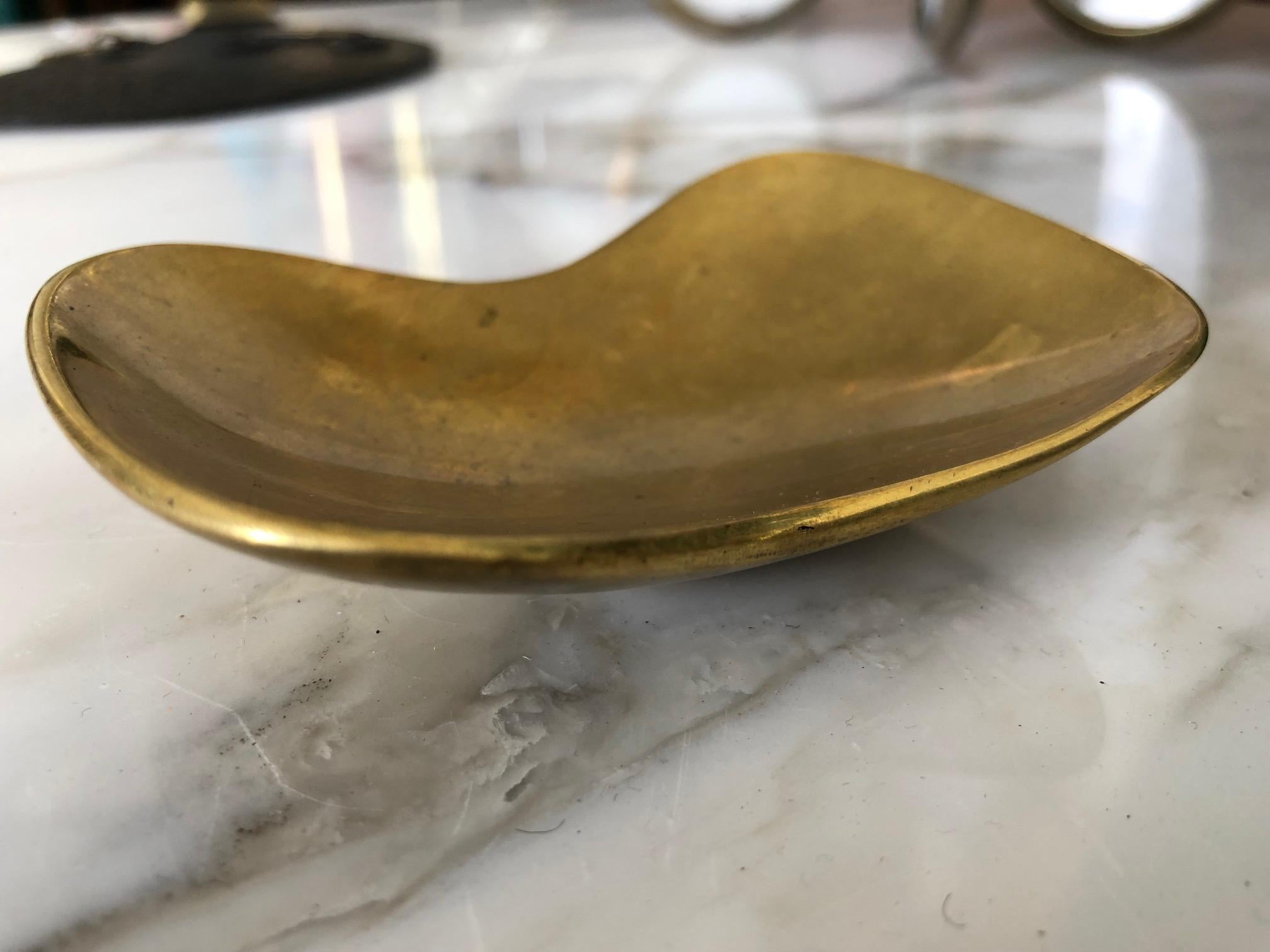 An unusual brass bowl by Carl Auböck. Unusual curves and shape add to the charm of this piece. Beautiful patina.