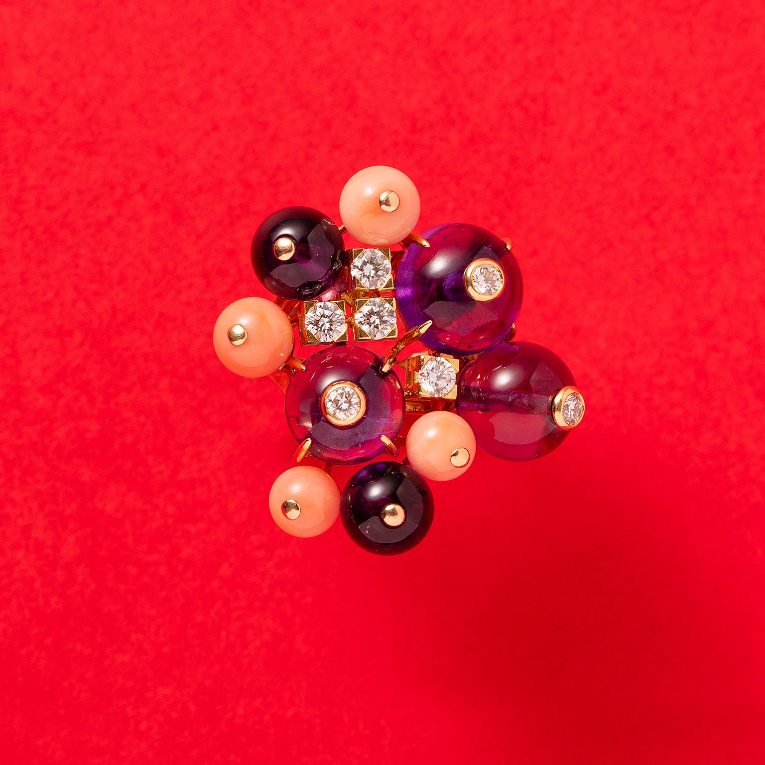 An 18 carat yellow gold ring with amethyst and coral beads, incrusted with diamonds and four brilliant cut diamonds in square-shaped chatons between the beads, signed and numbered: Cartier, 63396A, large model: 