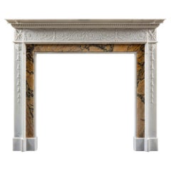 A Carved 19th century Georgian style Chimneypiece in Statuary and Sienna Marble