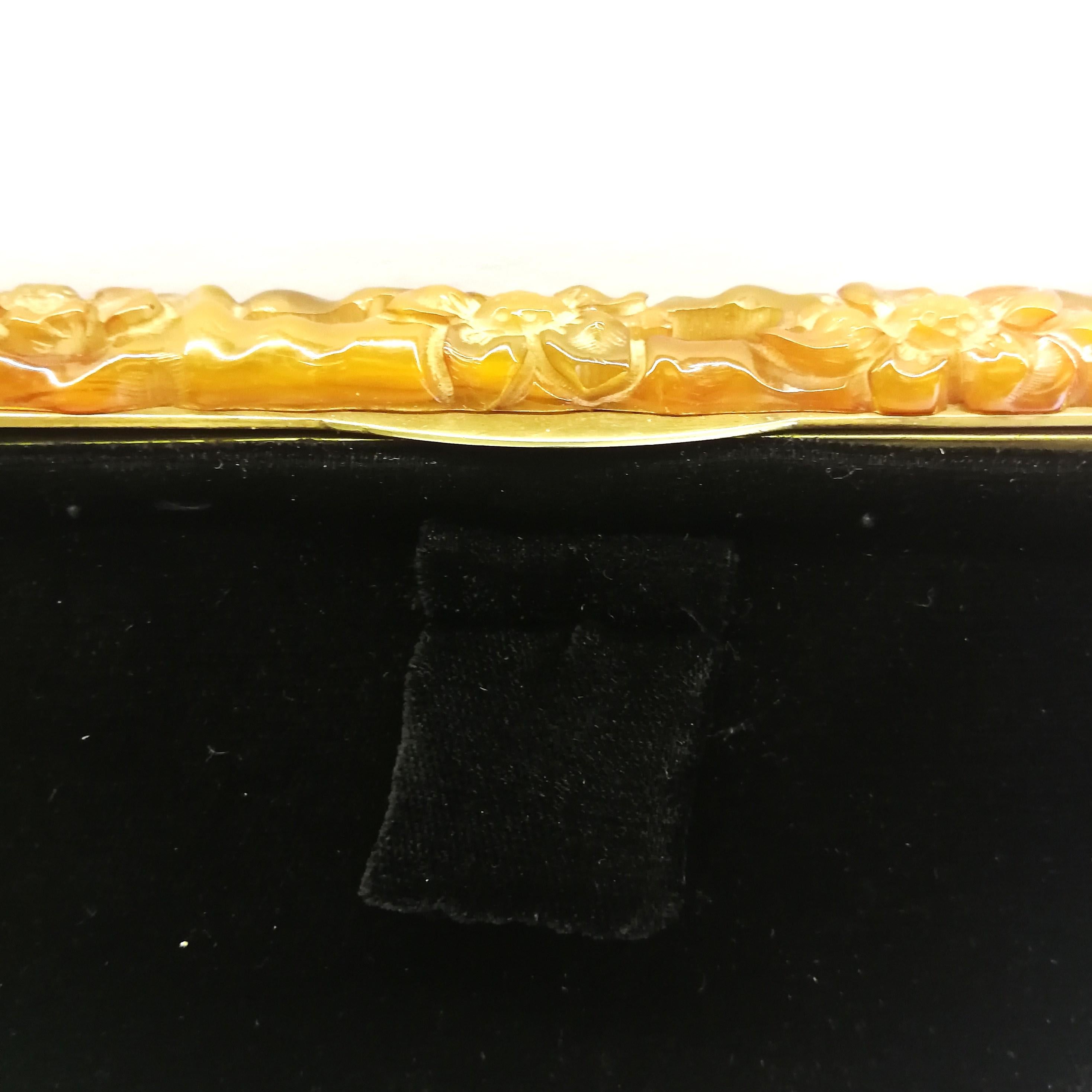 A carved amber Bakelite frame, and silk velvet clutch/handbag, 1930s. 1