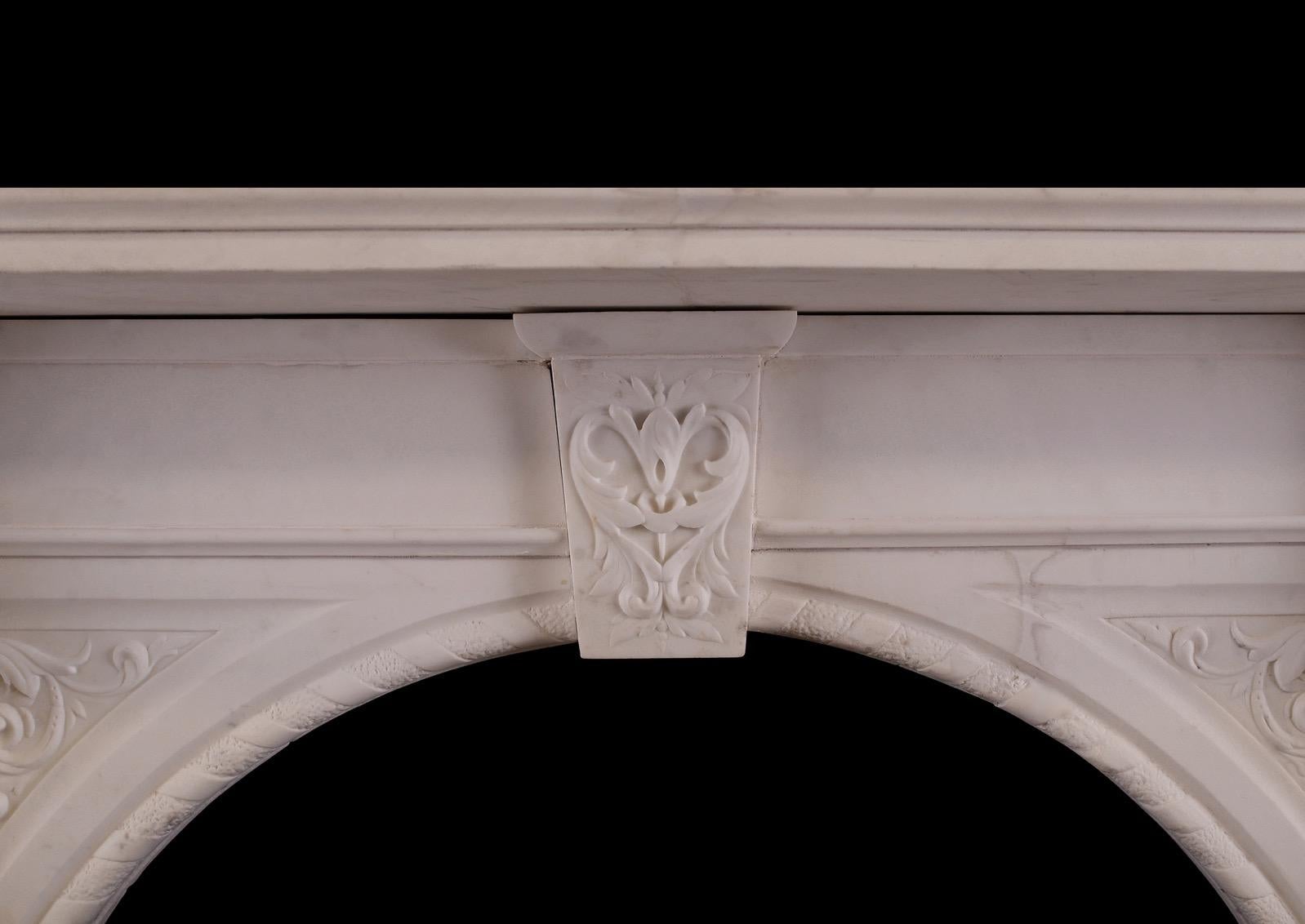 An impressive period Victorian fireplace in Statuary marble. The jambs carved with acanthus leaves to brackets, surmounted by delicately carved end blocks with bellflowers and scrollwork. The arched spandrels with inner rope moulding and scrollwork