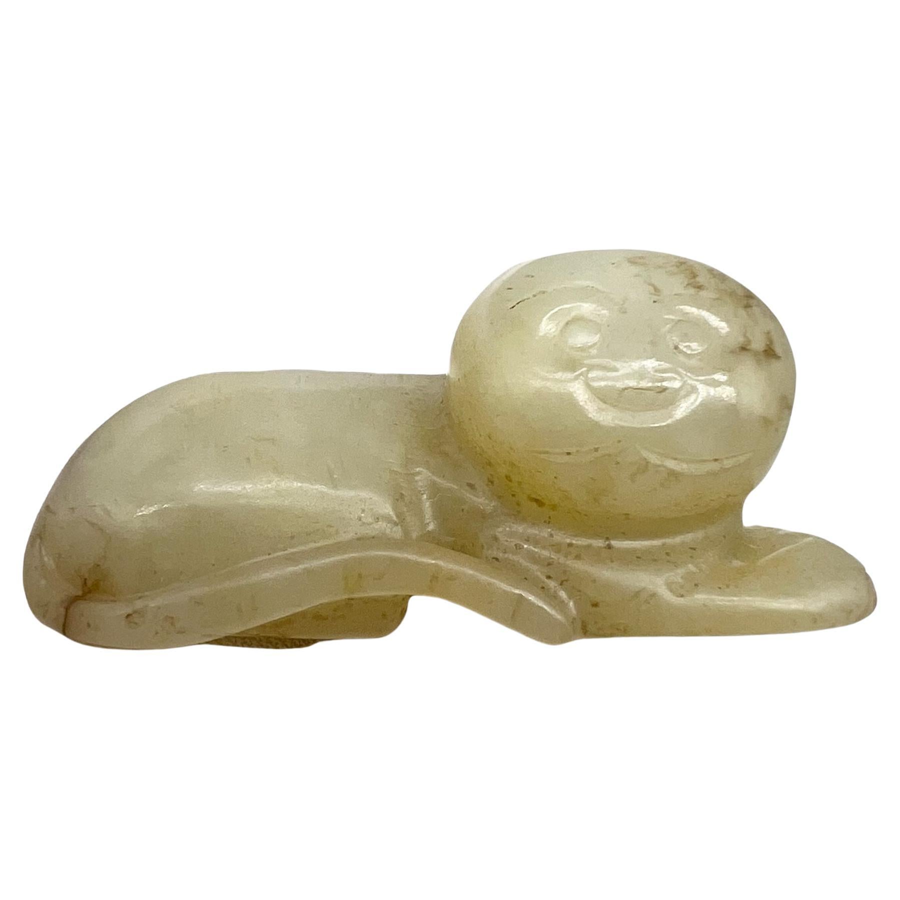 A Carved Celadon Jade Figure of a Recumbent Cat China, Qing Dynasty (1644-1912)