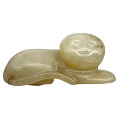 A Carved Celadon Jade Figure of a Recumbent Cat China, Qing Dynasty (1644-1912)