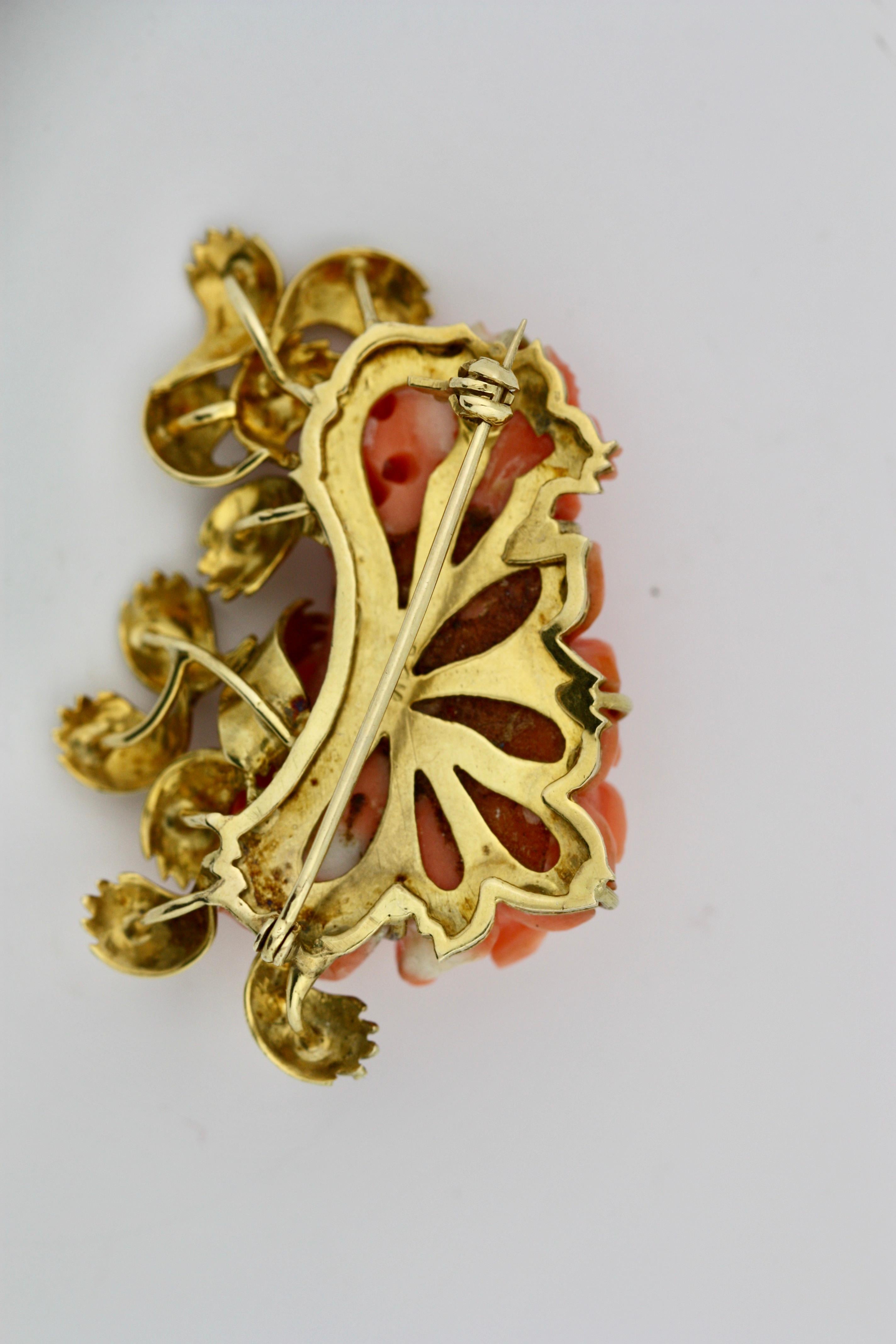 
A carved Coral Brooch
Of a rose motif carved from coral. 
Backed by a gold plaque with brooch attachment.
25 grams (gross) 
length 2 1/4 inches; 
