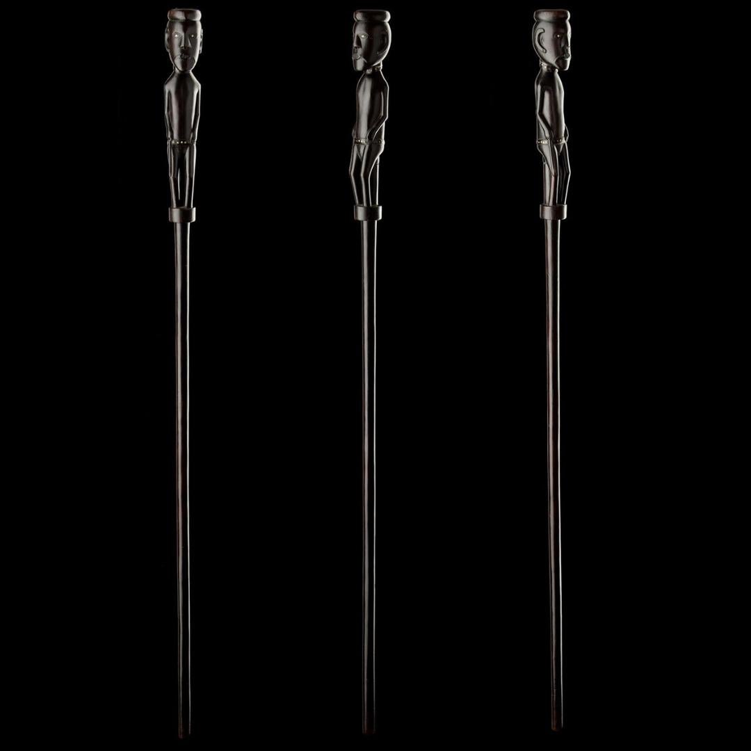 A Carved Ebony Prestige Staff Depicting an Important Elder or Leader wearing a Head-Ring ‘Isicoco’
His waistband neck-ring and eyes inlaid with brass studs, his hands carved to his sides, one holding a knobkerrie resting seated on a pillar, his