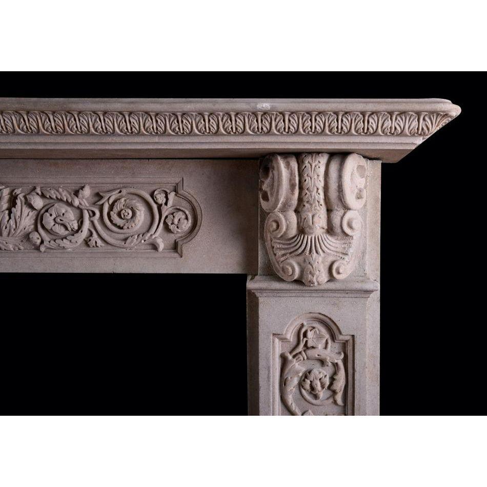 A carved stone English fireplace in the Gothic manner. The jambs with panels carved with scrolled foliage throughout surmounted by end blocking with carved cartouche and shell. The frieze with matching panel and carving, with foliage to centre. The