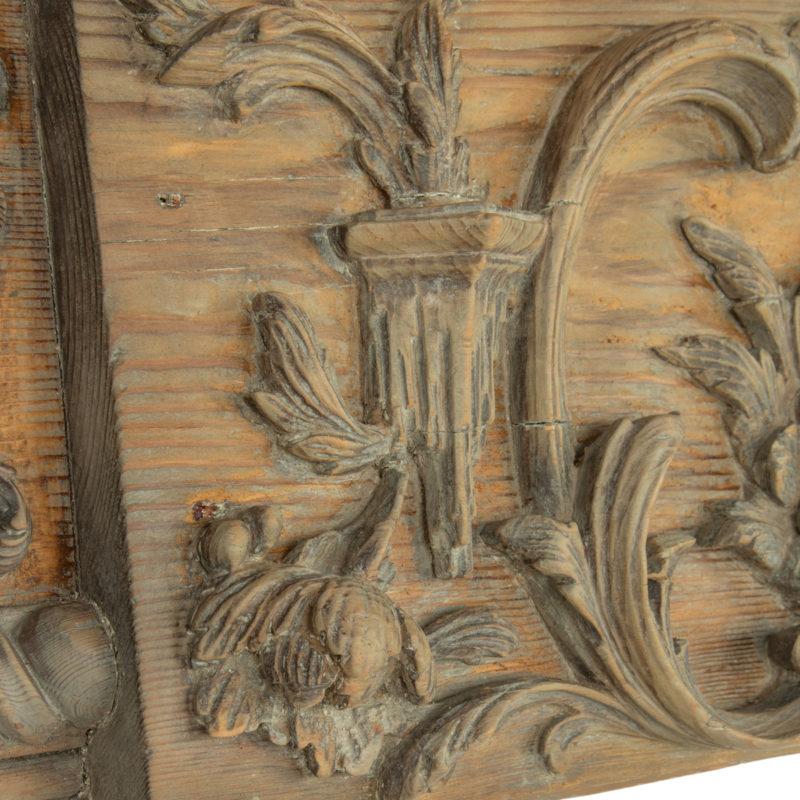 A carved fire surround from Sir Winston Churchill’s drawing room. This carved pine fire surround combines elements of both Rococo and Palladian designs.  It has a shaped cornice above a frieze of foliate arabesques and floral garlands centred on a