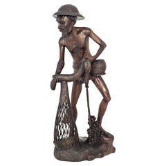 Antique A carved hardwood figure of a fisherman circa 1900