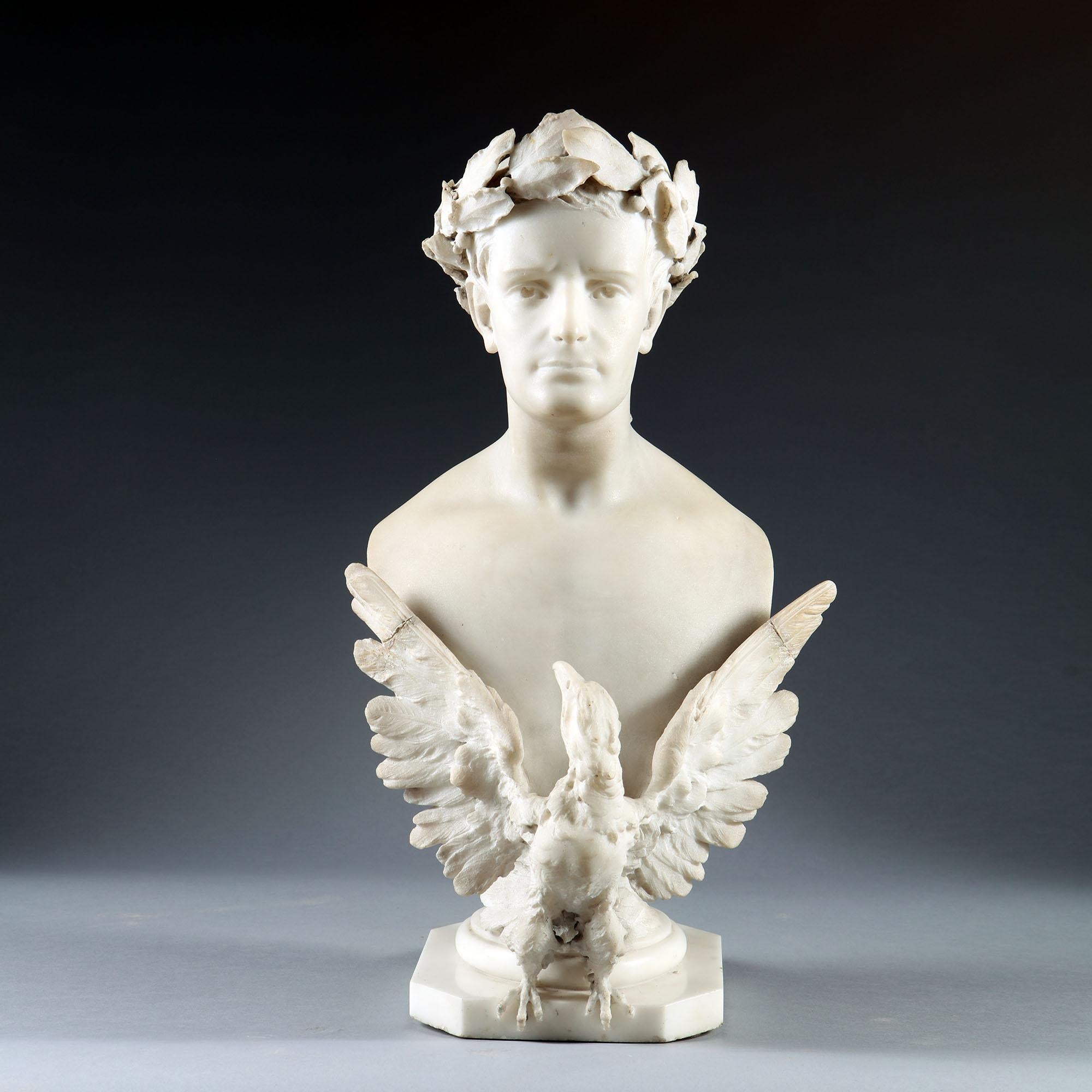 A carved marble bust of Napoleon, early to mid-19th century, depicted wearing a laurel crown and with an imperial spread eagle across his chest, on a circular to square turned socle.

