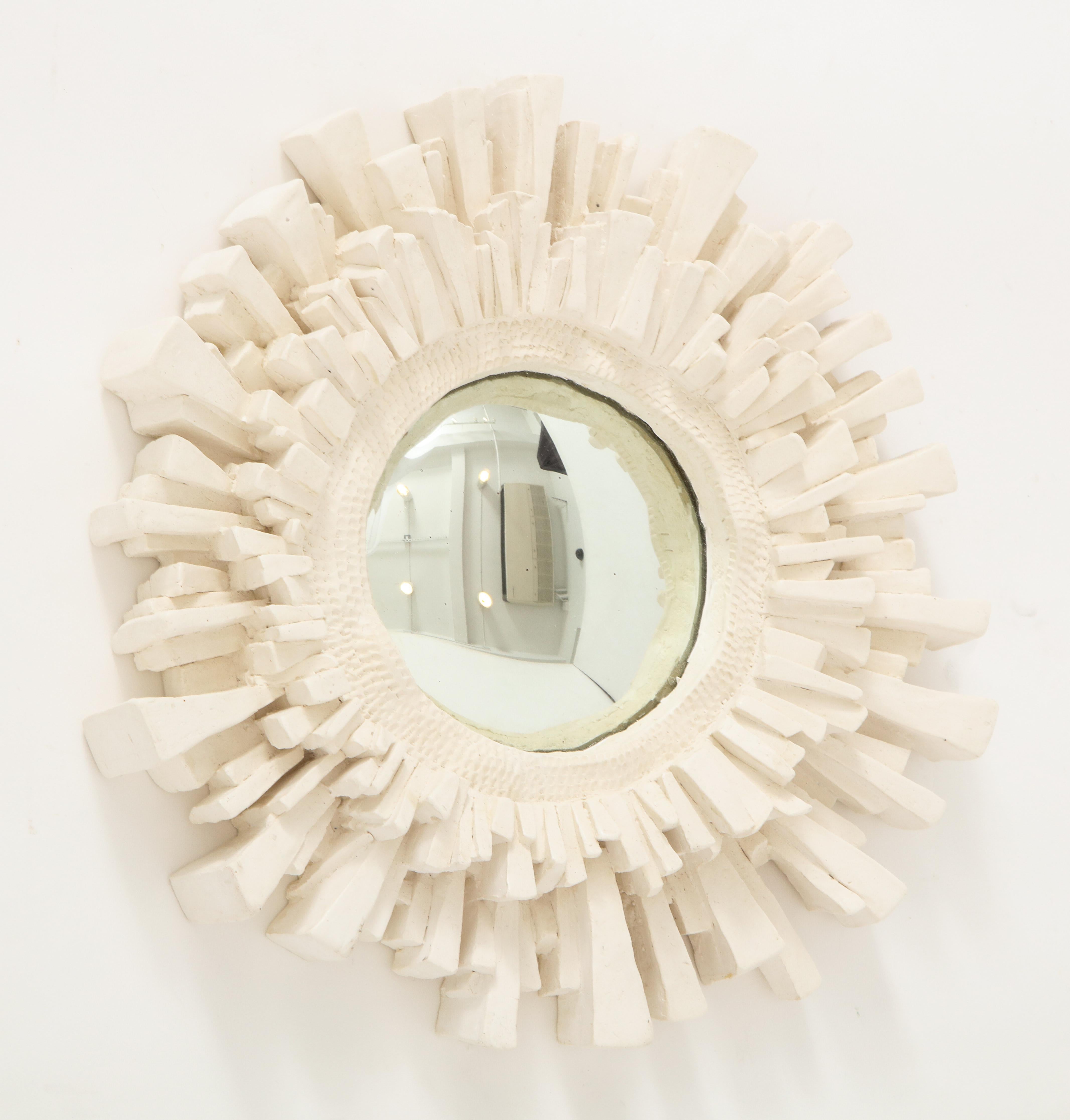 This plaster mirror in the shape of a sun, was created by the French sculptor Vincent V.  We love its wonderful texture, convex glass andi asymmetrical form.  Its clean, neutral color make it suitable for any color scheme.  One of several in our
