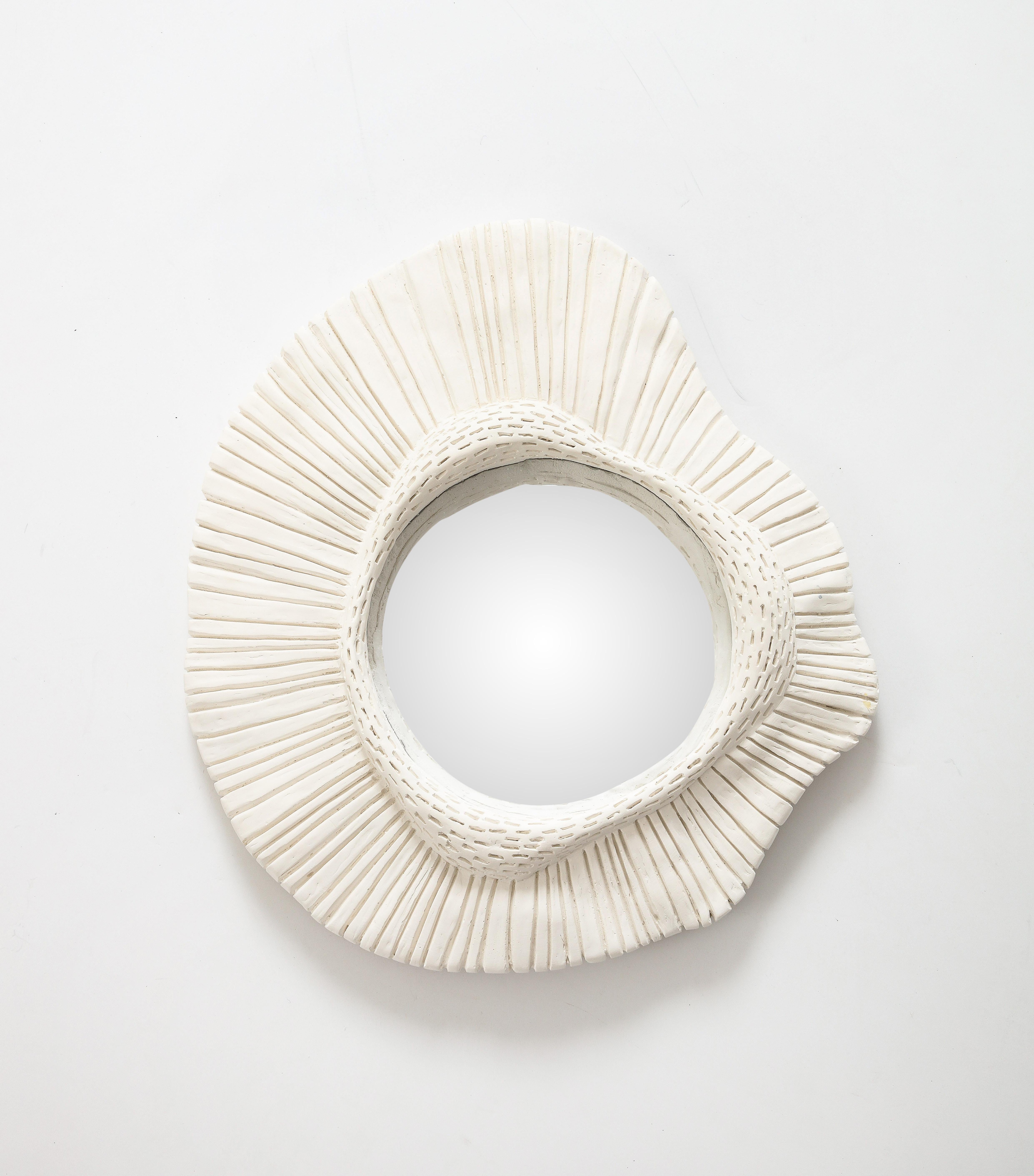 One of a series in our inventory, this carved plaster mirror with convex glass is stunning on its own or as part of a collection its asymmetrical shape and interesting texture make it a unique piece, suitable for a traditional or contemporary