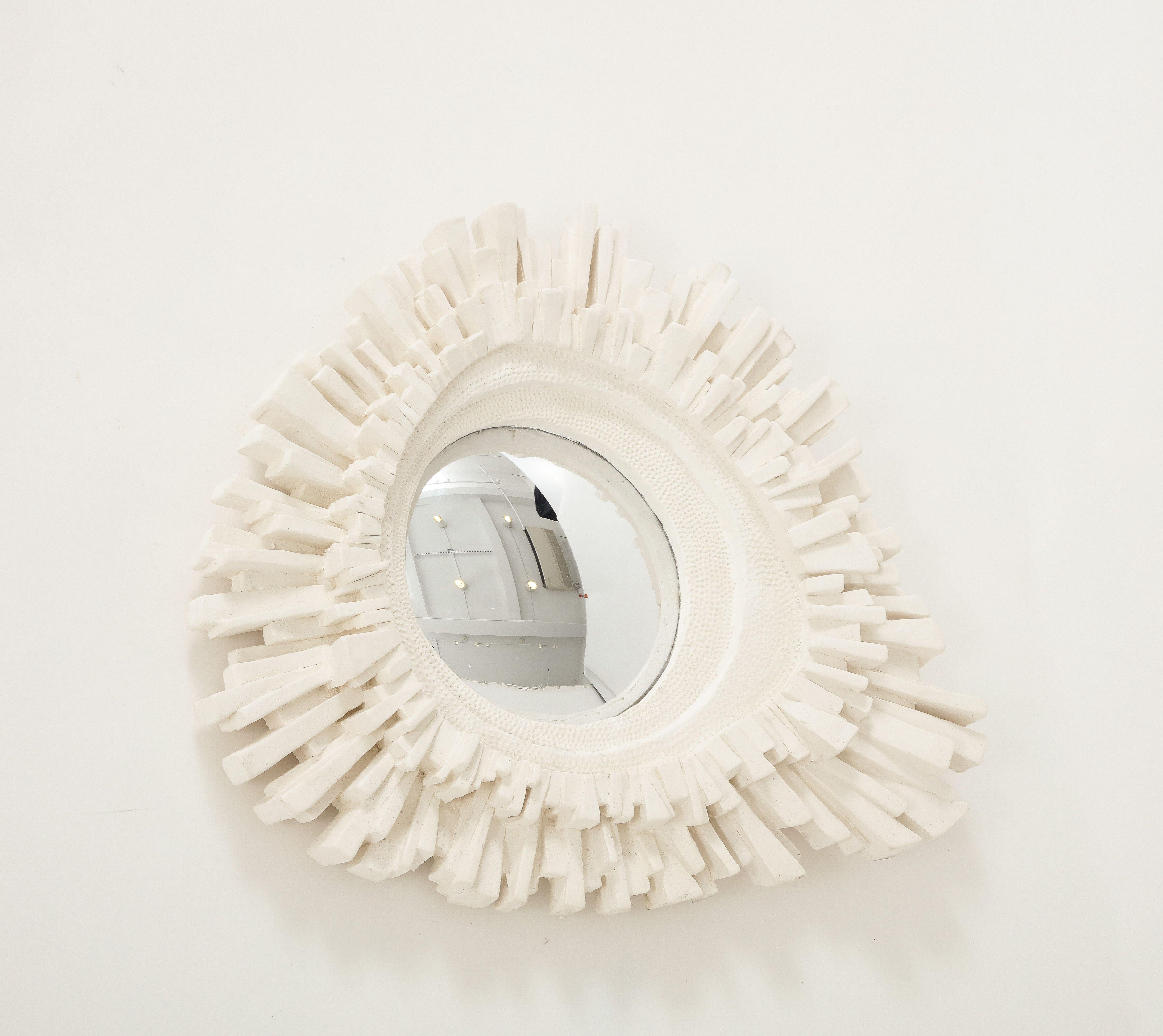 One of a series in our inventory, this carved plaster mirror with convex glass is stunning on its own or as part of a collection. its asymmetrical shape and interesting texture make it a unique piece, suitable for a traditional or contemporary
