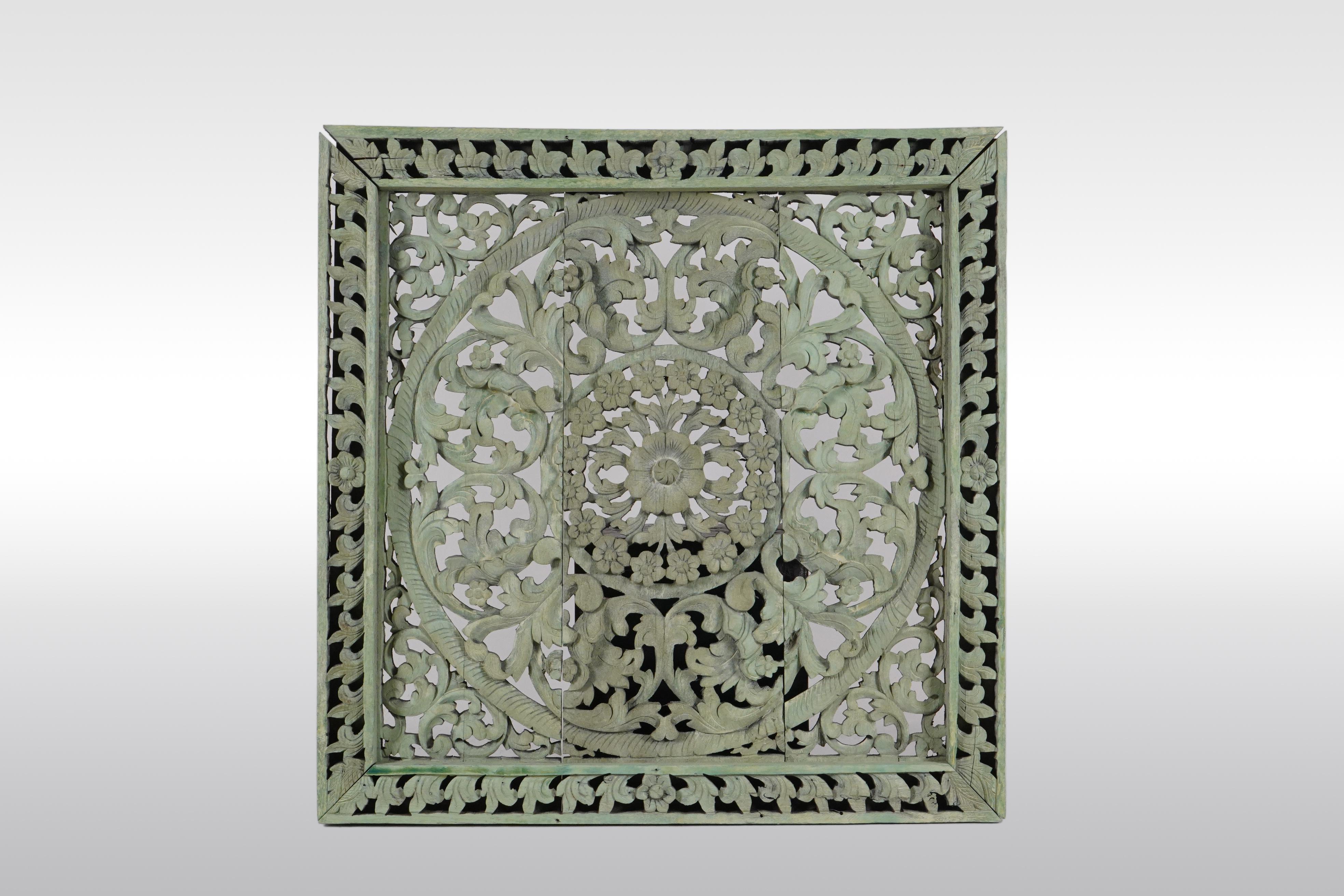 This is a meticulous recreation of an antique Thai temple ceiling panel. Northern Thai temples often had intricately carved wooden ceilings made up of coffered panels with carved and gilded lotus flowers in their centers. The overall effect was of a