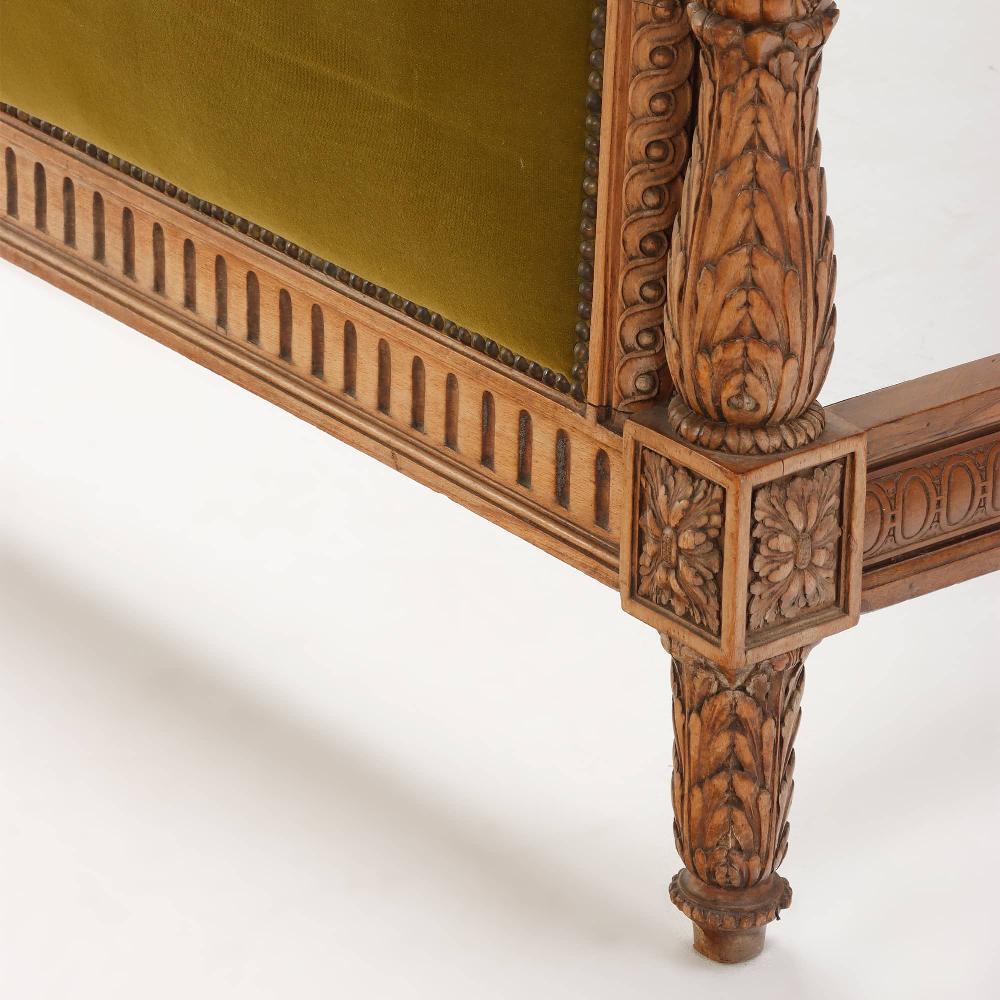 Early 20th Century A carved walnut French bed having a shaped head and footboard circa 1920.