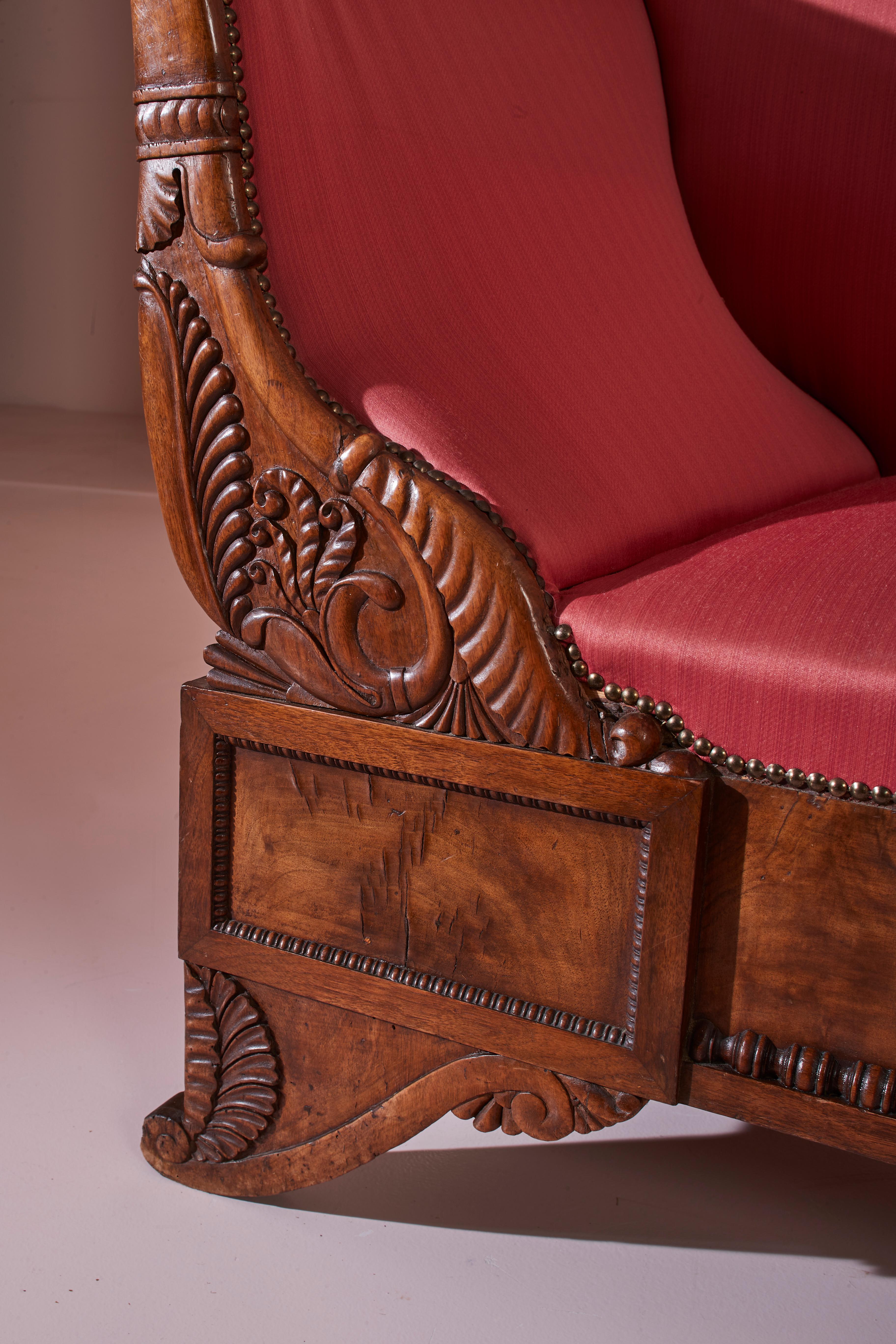 Italian A carved walnut sofa with boat-shaped form in the style of Henry Thomas Peters For Sale