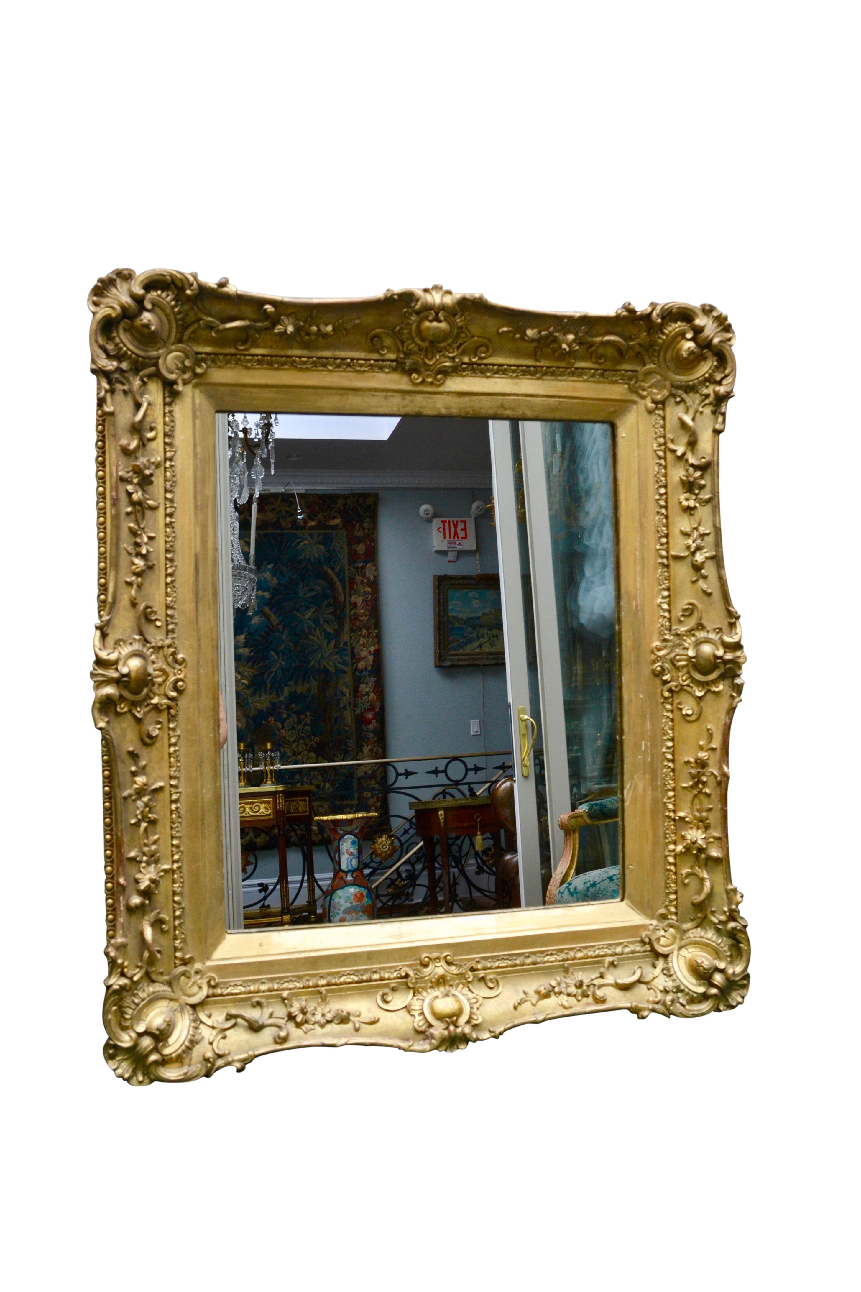 A fine model 18th century French framed mirror. The style of mirror originated in the mid-18th century in France and has been popular ever since. The carved wood and gesso frame has been gilded as has the filet around the mirror. The mirror has been
