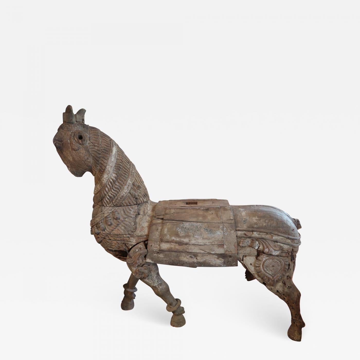 A carved wood horse, Mogol period, India 17th century. Distressed.